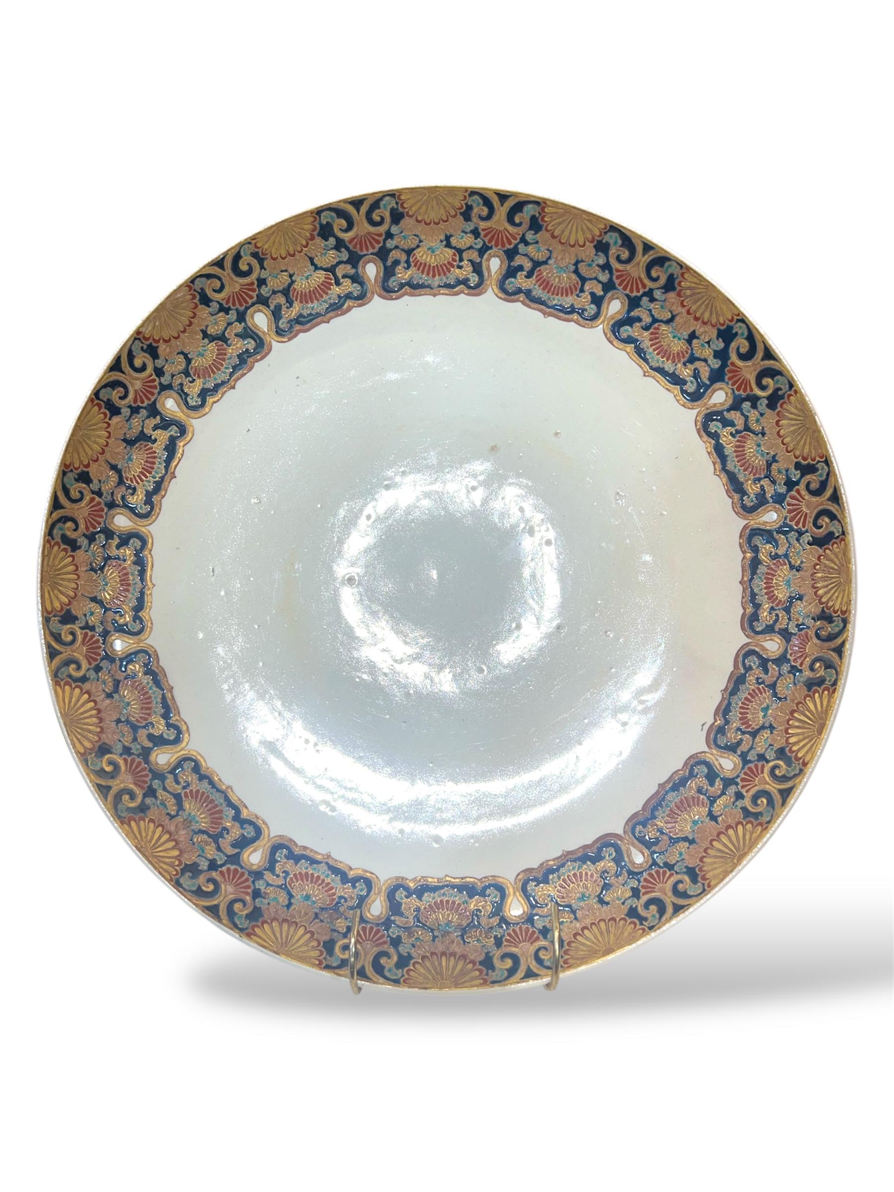An Imperial Japanese Satsuma Charger
By Masanobu, Meiji era

Of large circular form, the wide rim lavishly decorated in raised polychrome enamels and gilt with a continuous border of Imperial chrysanthemums (kiku) in full bloom, interwoven with