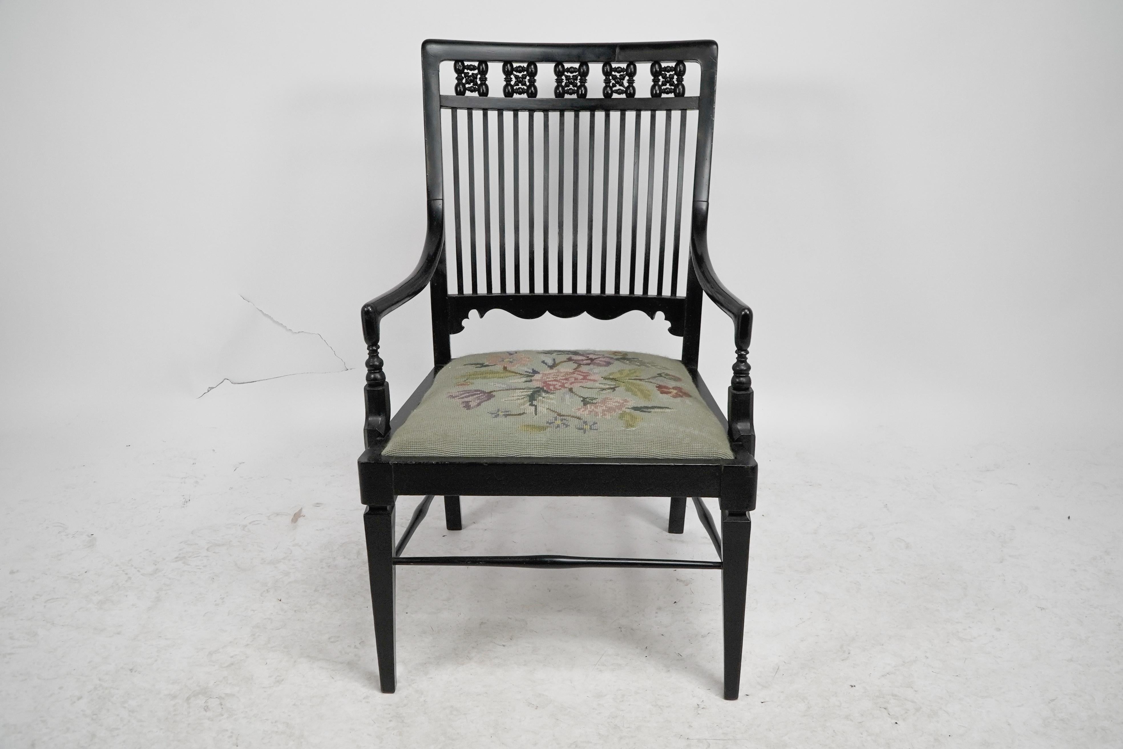 Aesthetic Movement Liberty & Co armchair with a shaped back & mashrabiya turnings to the head rest. For Sale