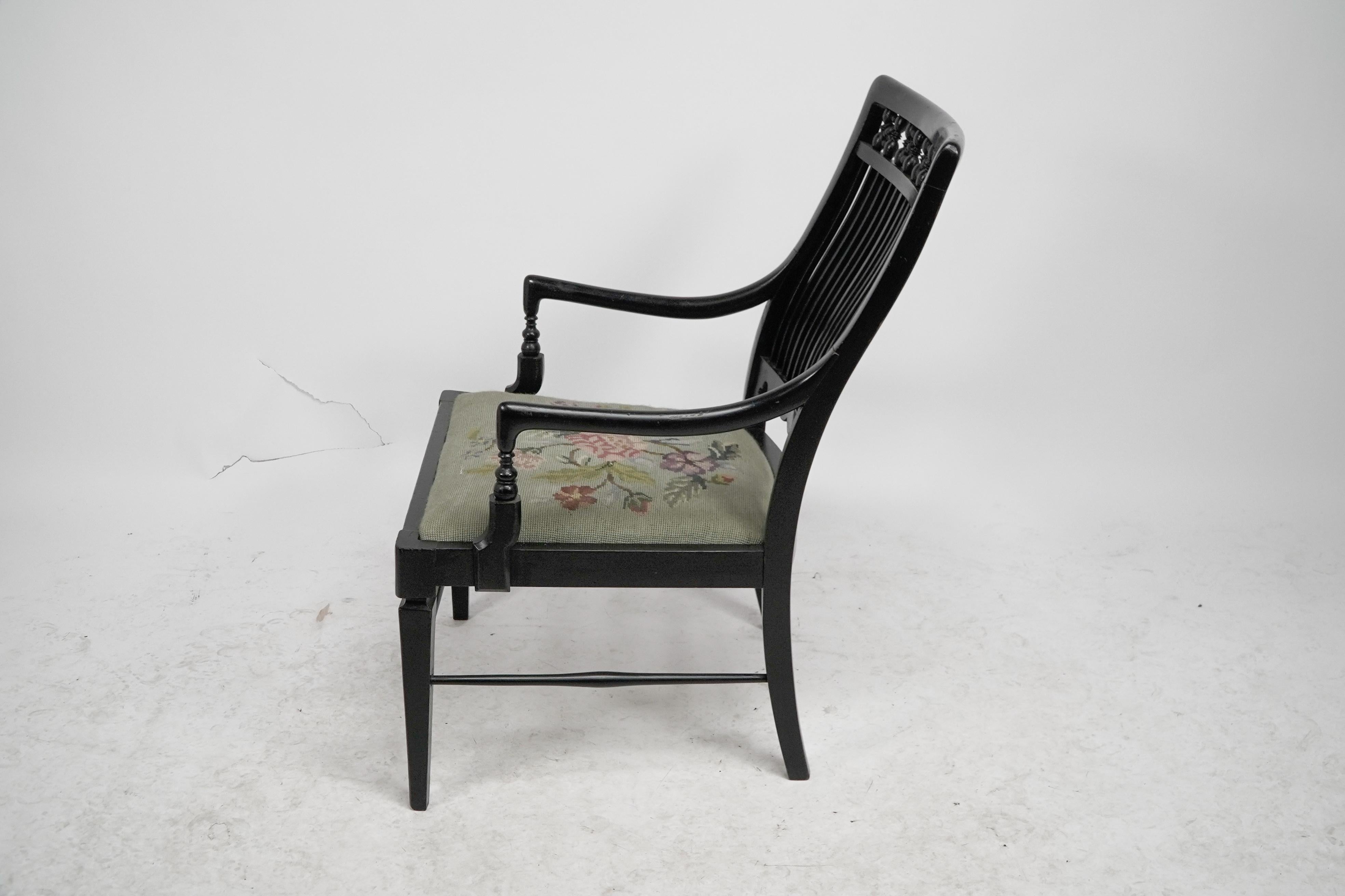 Liberty & Co armchair with a shaped back & mashrabiya turnings to the head rest. In Good Condition For Sale In London, GB