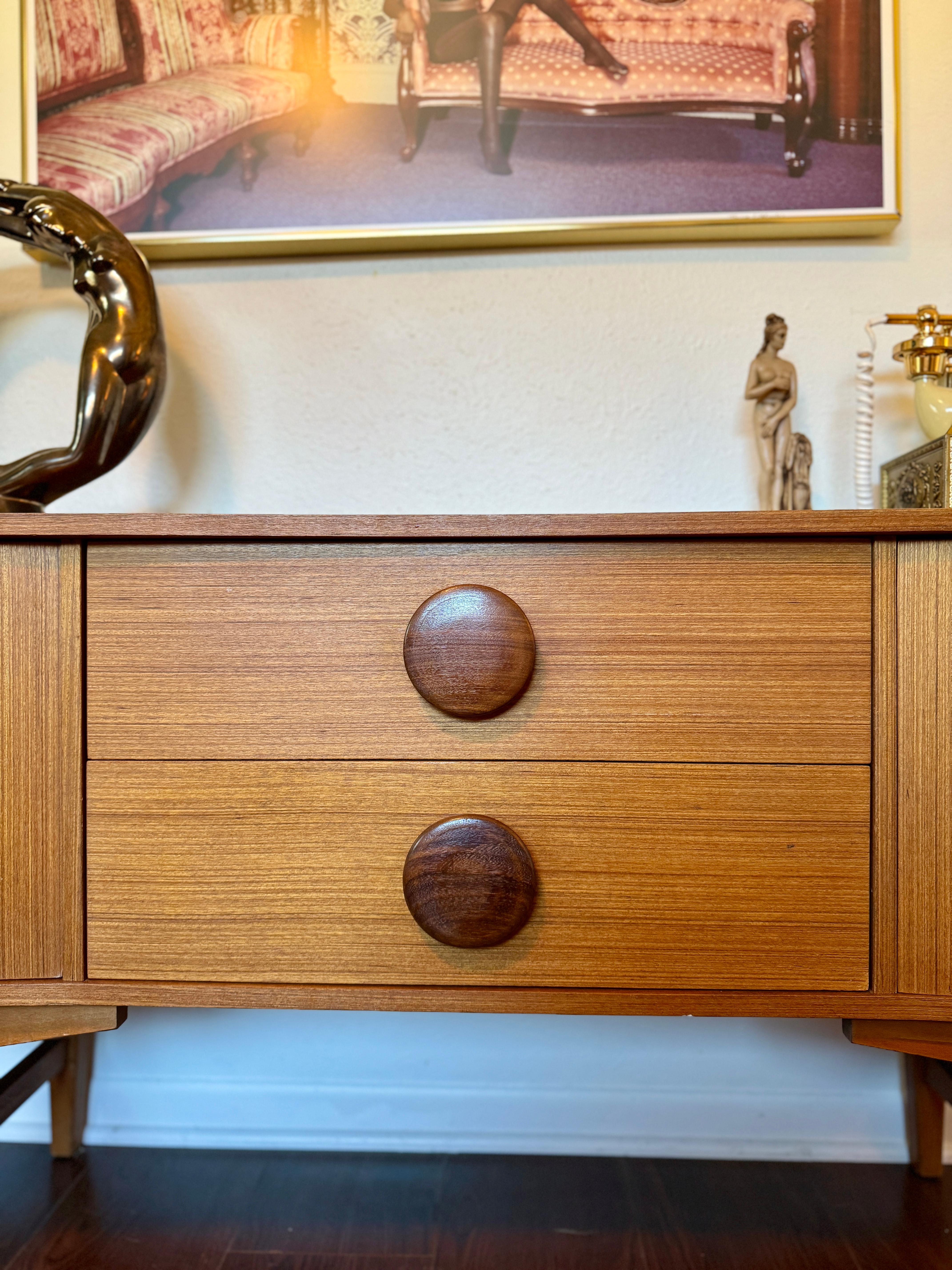 Teak An MCM petite sideboard with button pulls, circa 1960s