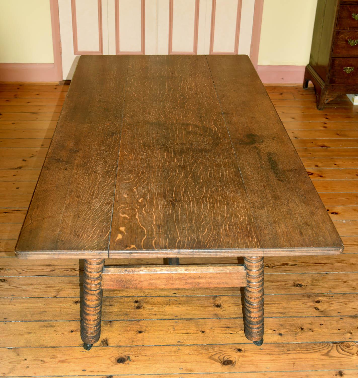 A wonderful 19th century table with a four plank top with moulded edge on four ring turned legs joined by chamfered stretchers and terminating in the original sunken brass castors.
Designed and made by Phillip Webb for William Morris & Co., circa