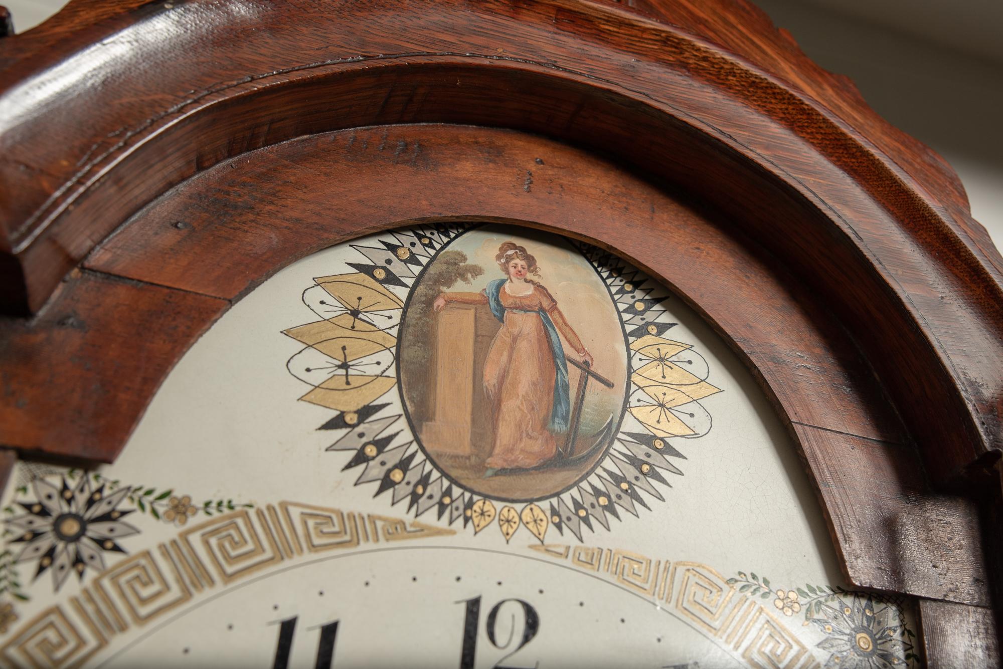 A very good, solid oak case, 8 day arched painted dial clock striking the hours, by Payne of Hadleigh. 
Depicting Lady Hamilton, mistress to Admiral Horatio Nelson, painted to the arch.
The movement with striking the hours on a single bell and