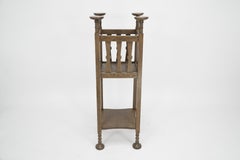 Shapland & Petter. Arts & Crafts oak plantstand with Voysey style disc finials.