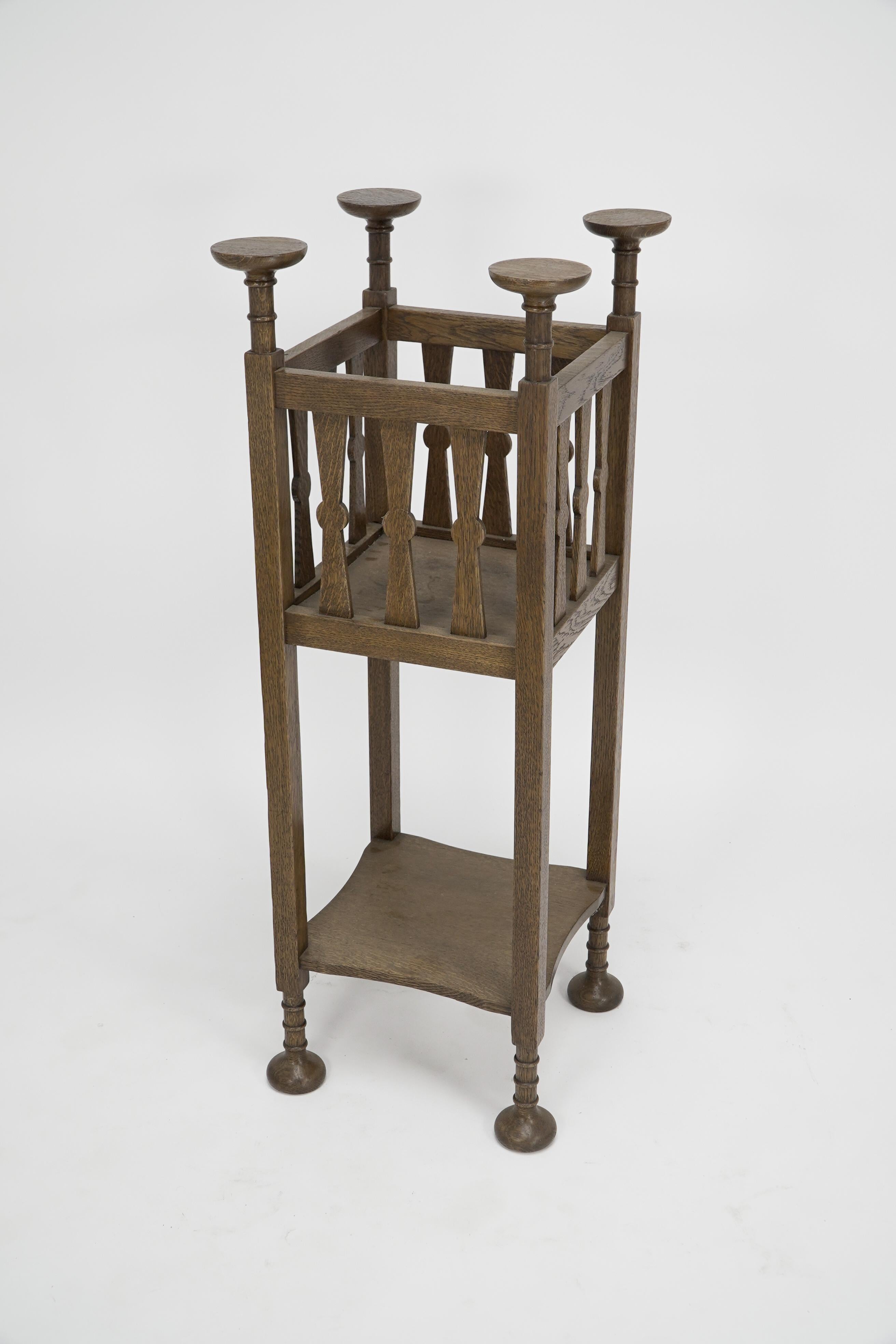 Shapland & Petter. Arts & Crafts oak plantstand with Voysey style disc finials. In Good Condition For Sale In London, GB