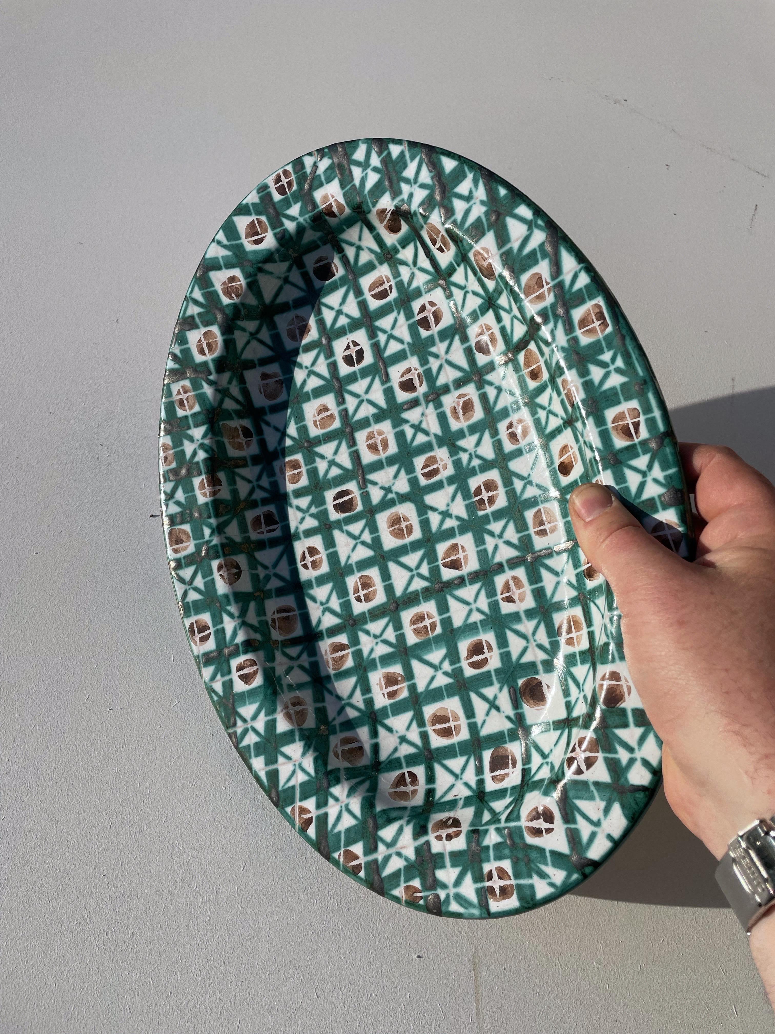RareRare oblong glazed ceramic platter signed on the reverse by Robert Picault, an iconic figure of the Vallauris ceramics movement in the 1950s. This piece features a refined geometric design, characteristic of the artist’s style, with hand-painted