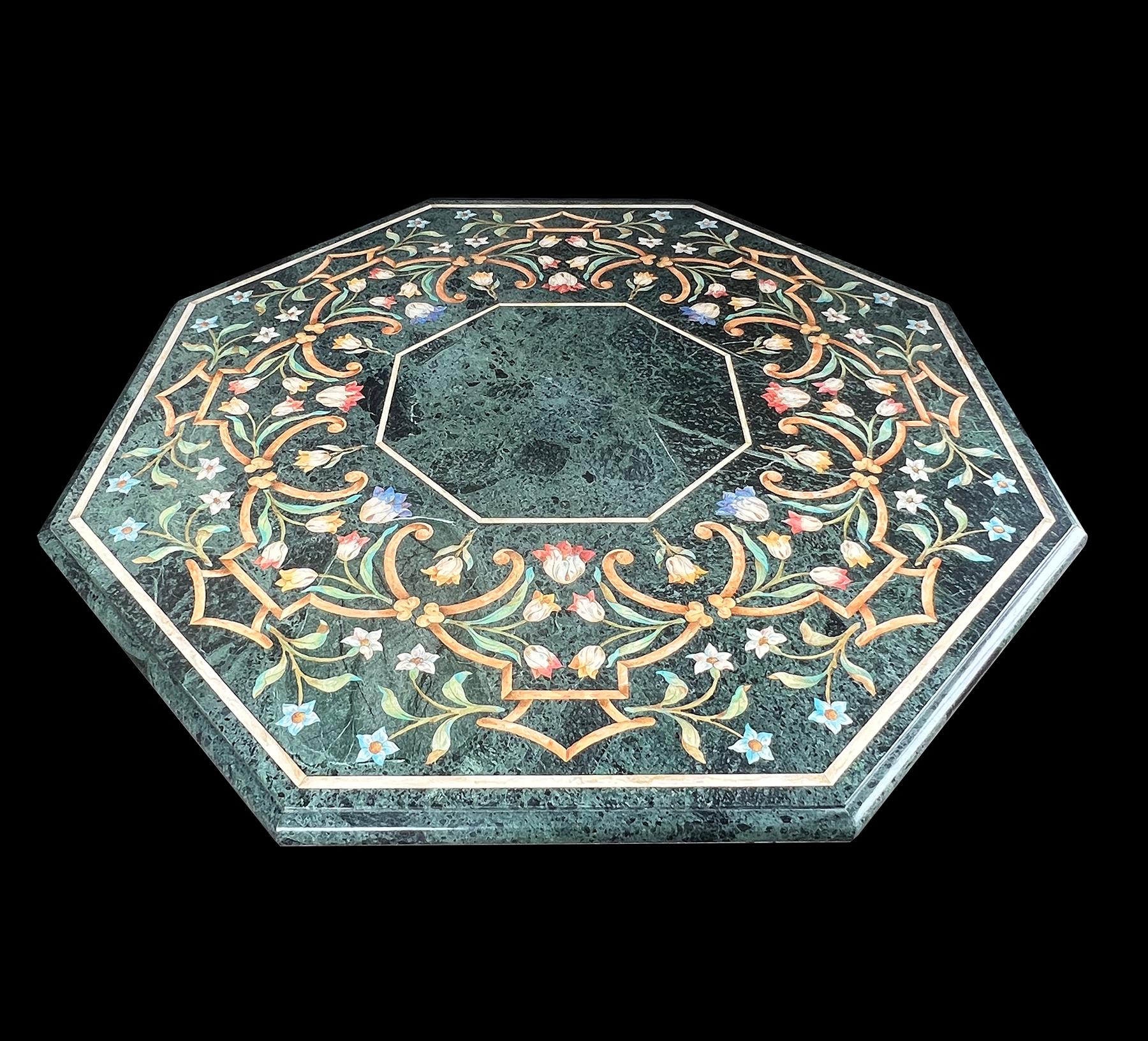 the octagonal forest-green marble top with painted inlaid scrollwork surrounded by floral and foliate decoration; all raised on a neoclassical style Michael Taylor faux stone cross tripod lyre base