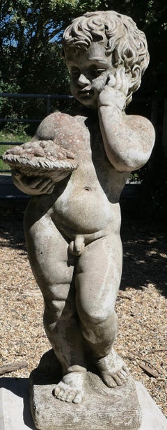 An Old Weathered Nude Boy Garden Statue   This is a lovely old statue of a boy