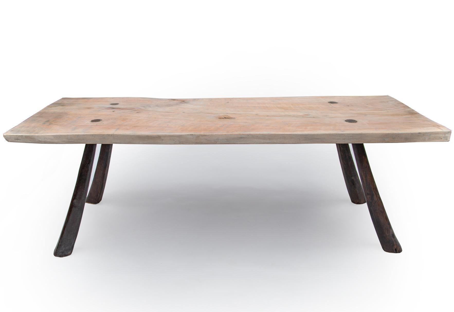 Mallorca, first quarter of the 20th century

The table top crafted from a single plank of olive wood. Each leg chosen with a natural organic splay in the wood movement. Beautifully handcrafted using traditional wedge dowel joining methods and of