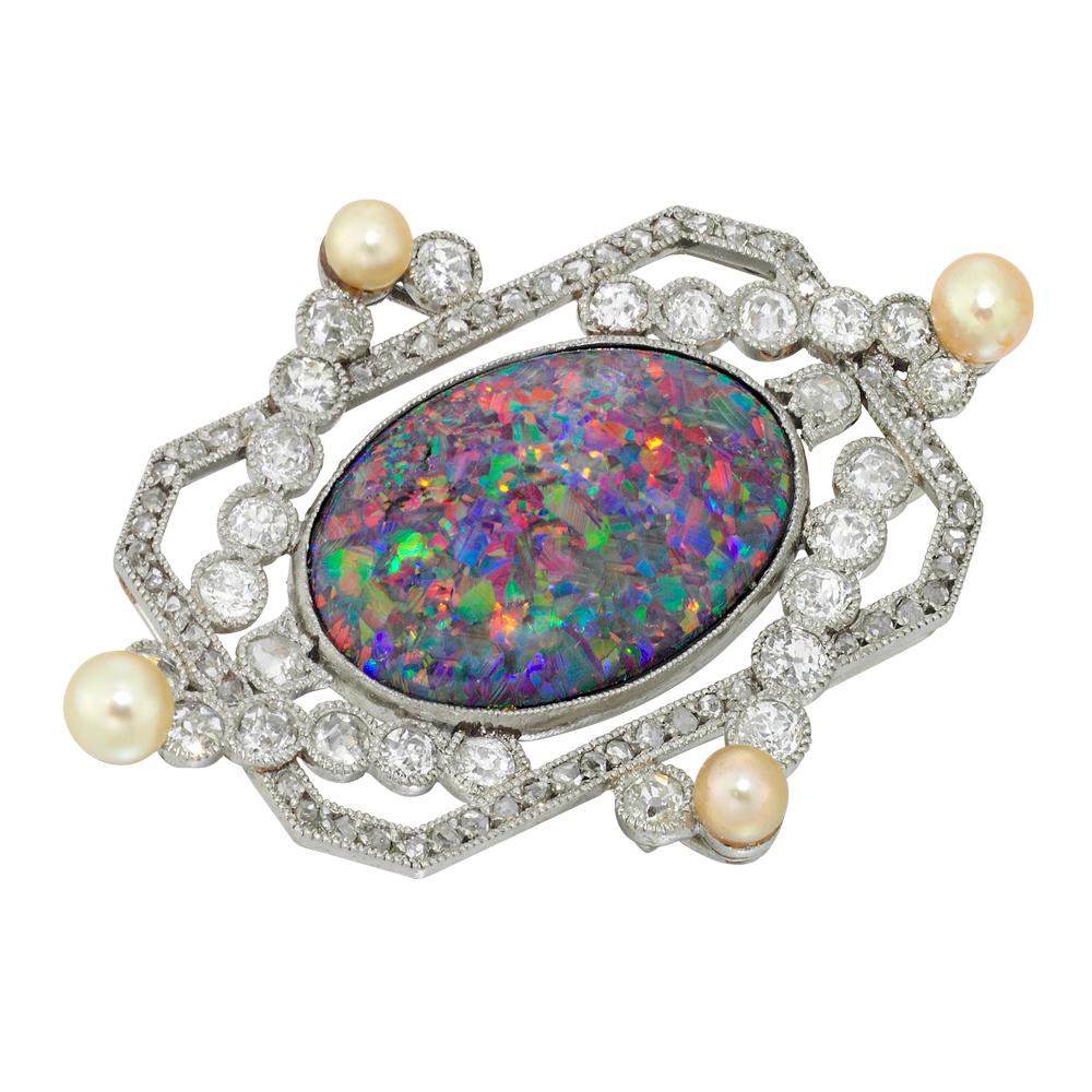 An early 20th century opal and diamond brooch, the oval cabochon-cut black opal, measuring approximately 1.8 x 1.2cm, to the centre of a rectangular rose-cut diamond-set surround with an additional overlapping frame of rubover-set old European-cut