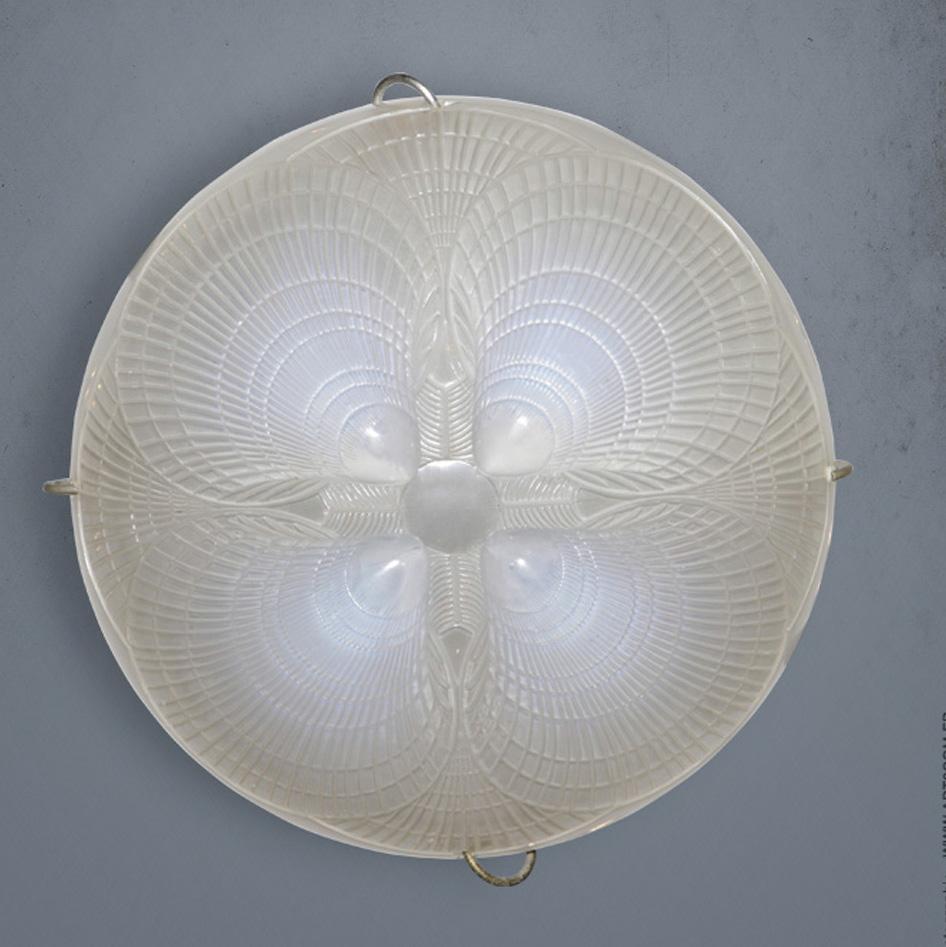 An opalescent glass Coquille pendant by R.Lalique in excellent condition.

The ropes and the cap are genuine and in excellent condition as well.

The signature is hand wheel carved in block lettres.

The bowl is 30 cm wide and 20 cm
