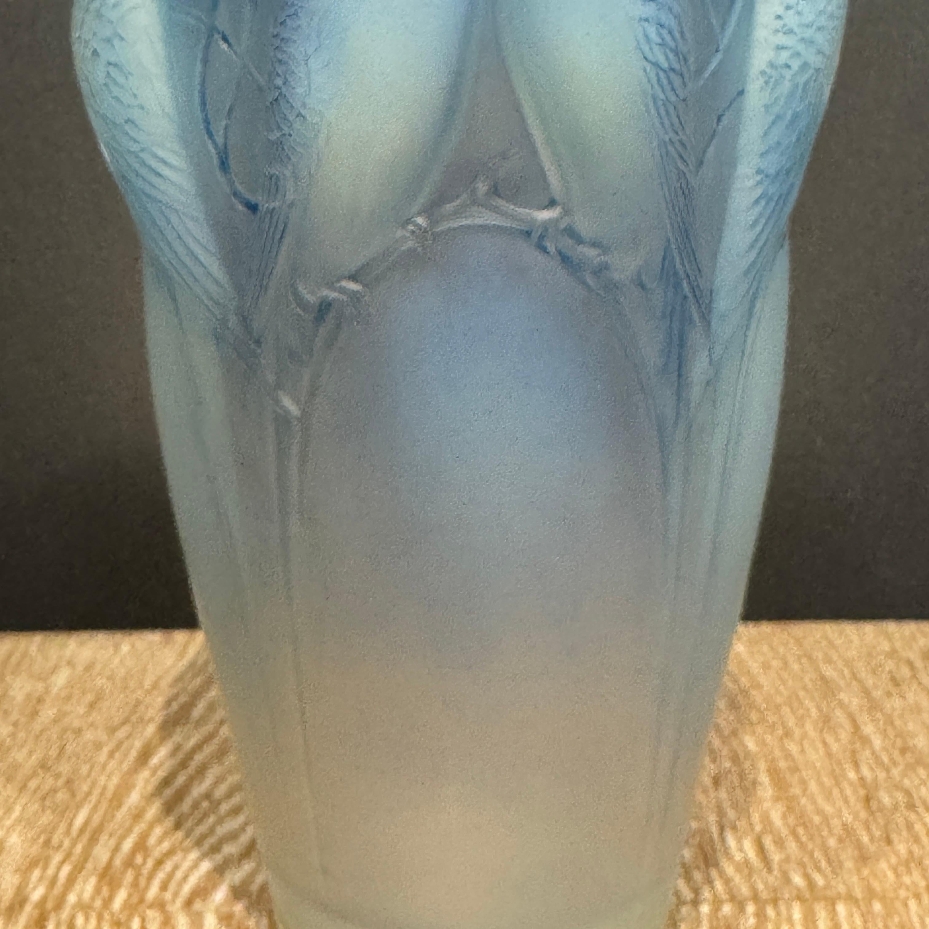 The Ceylan vase is created in 1924 by R.Lalique in white glass and has been since  its creation  a great hit.

This example is in excellent condition and has a strong’opalescence.

The vase has a blue patina .

The vase is hand signed in written