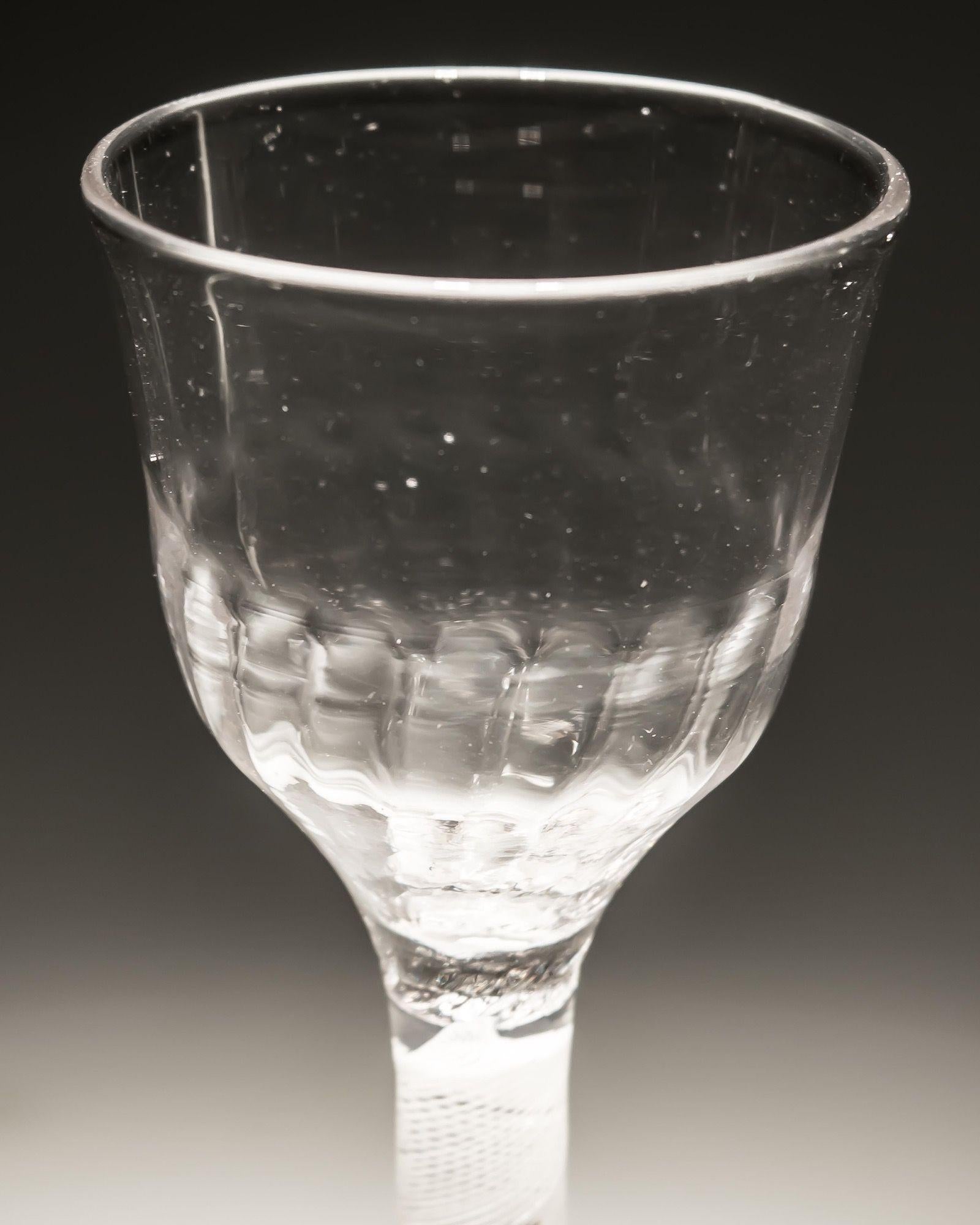 An opaque twist wine glass with ribbed bowl

England, circa 1760.