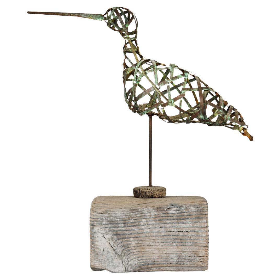 An openwork copper curlew with a long beak by Martin Scorey
