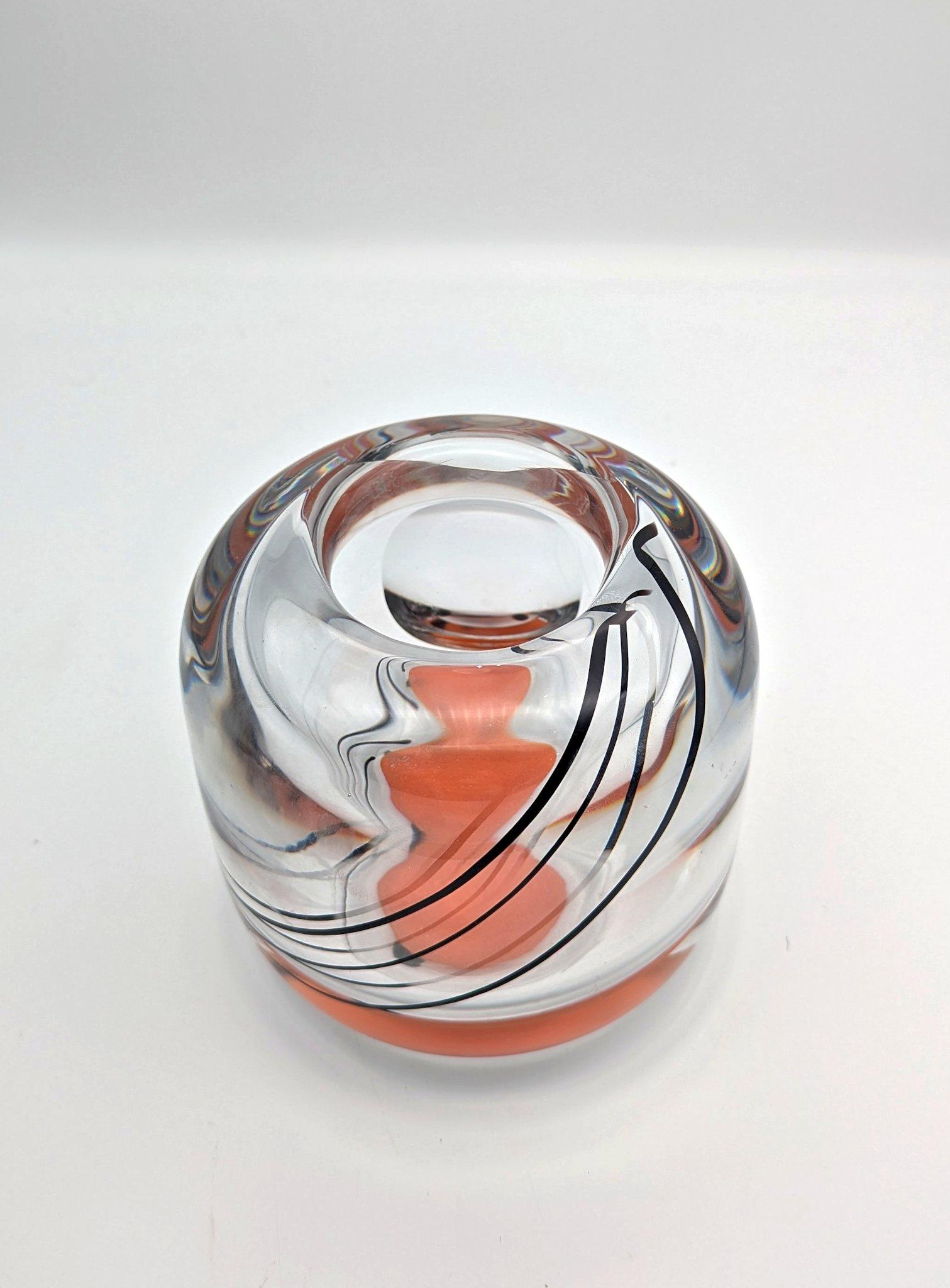 Un bon vase d'expo, conçu par Olle Alberius, réalisé en 1973 à la manufacture de verre Orrefors en Suède. Cette pièce, lourdement encaissée, est dotée d'un effet d'optique. La base comporte une couche de verre circulaire opaque orange insérée. Entre