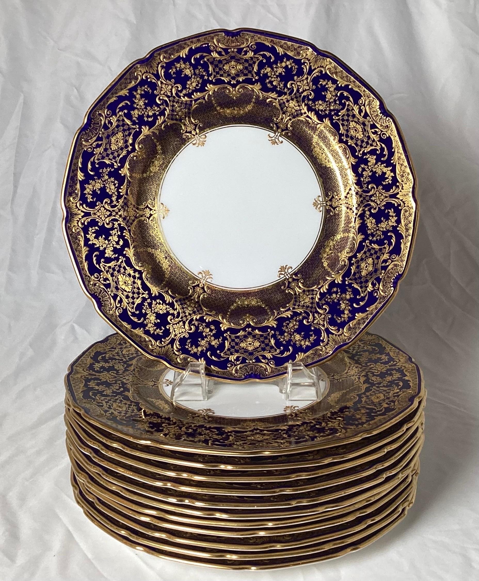 A set of regal cobalt blue and hand-painted raised gilt plates in unused condition. 
These plates were made by Royal Doulton with an artist signature 