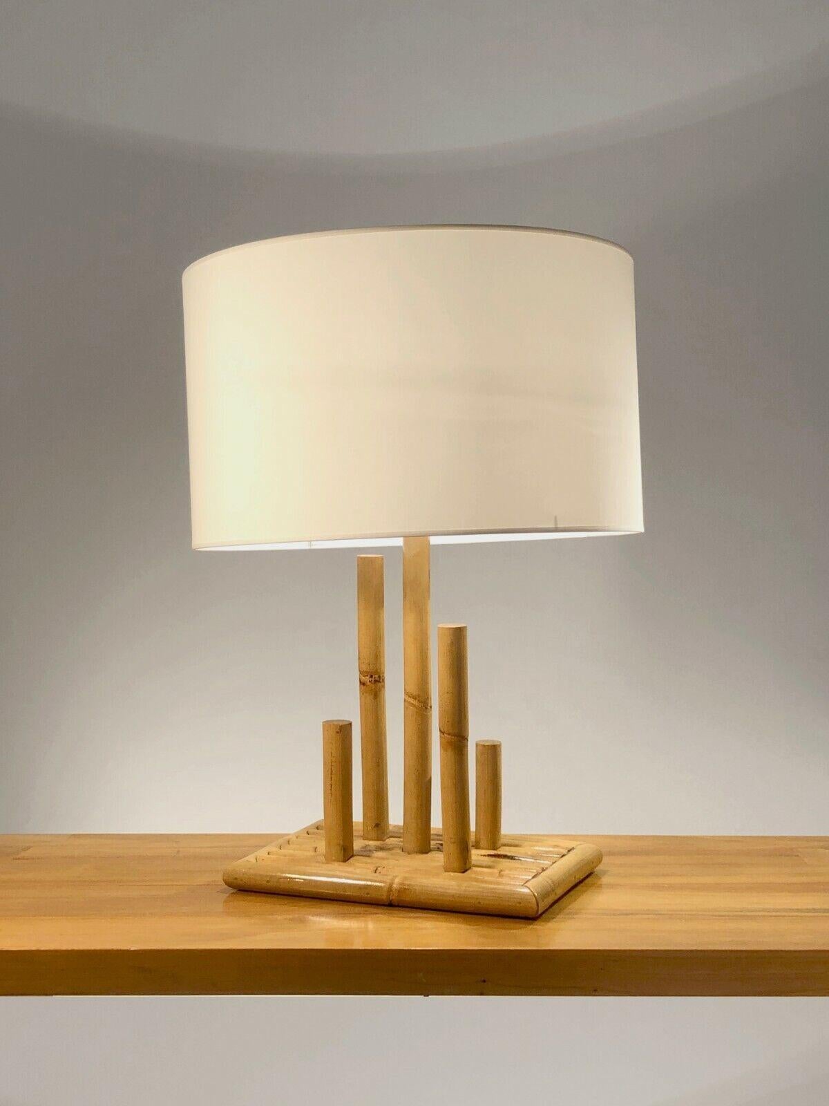 An interesting and graphic table lamp with 5 bamboos, Modernist, Free-Form, Brutalist, Rustic-Modern, Popular Art, rectangular bamboo base, planted with 5 axes of different sizes in bamboo forming a real graphic composition, the axis central and the