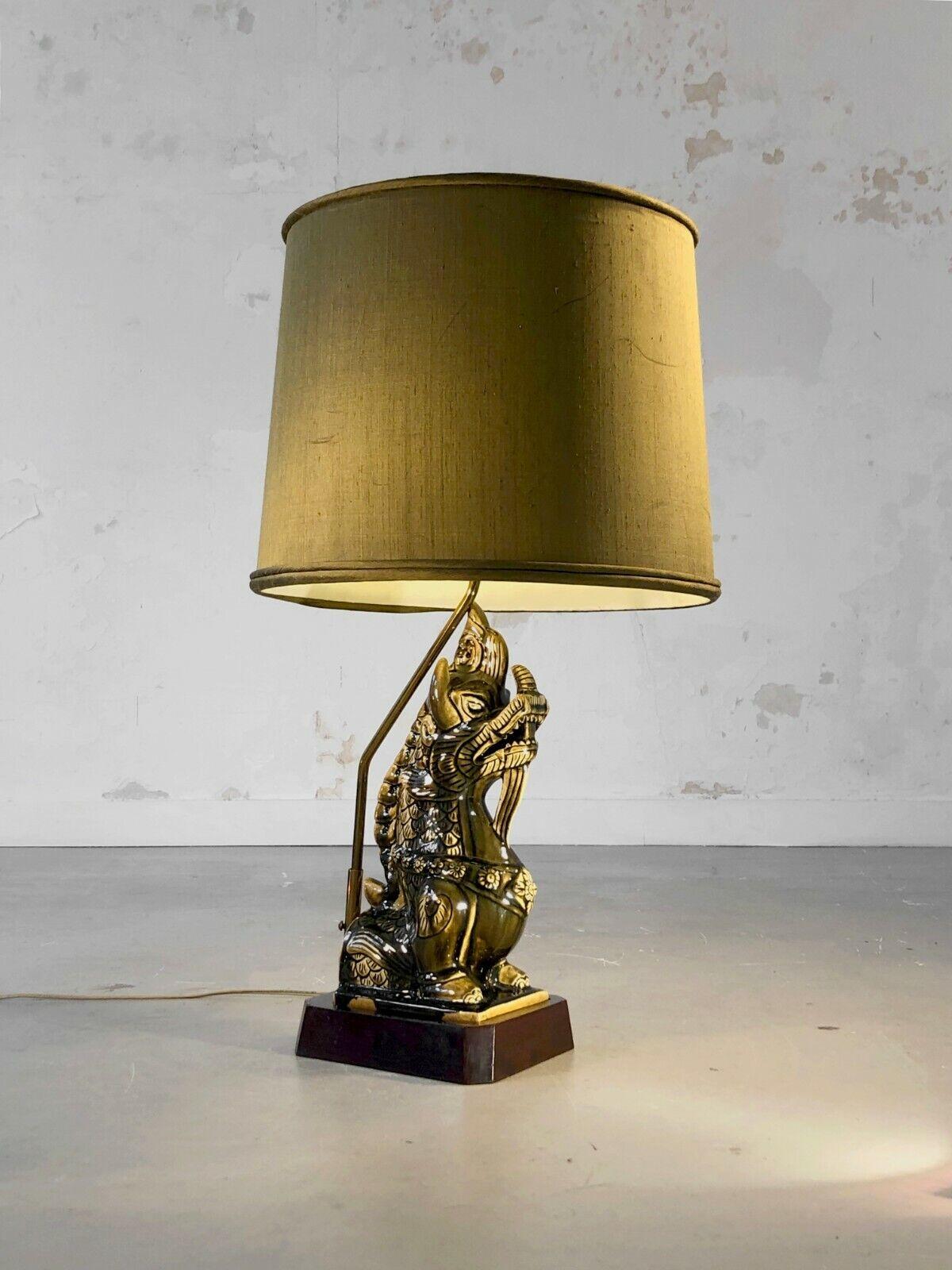 A spectacular, very large and massive dragon table lamp, Chinese, Orientalist, Shabby-Chic, Zoomorphic, thick wooden base, important dragon sculpture in khaki green enameled ceramic, large original circular lampshade in khaki fabrics, to be