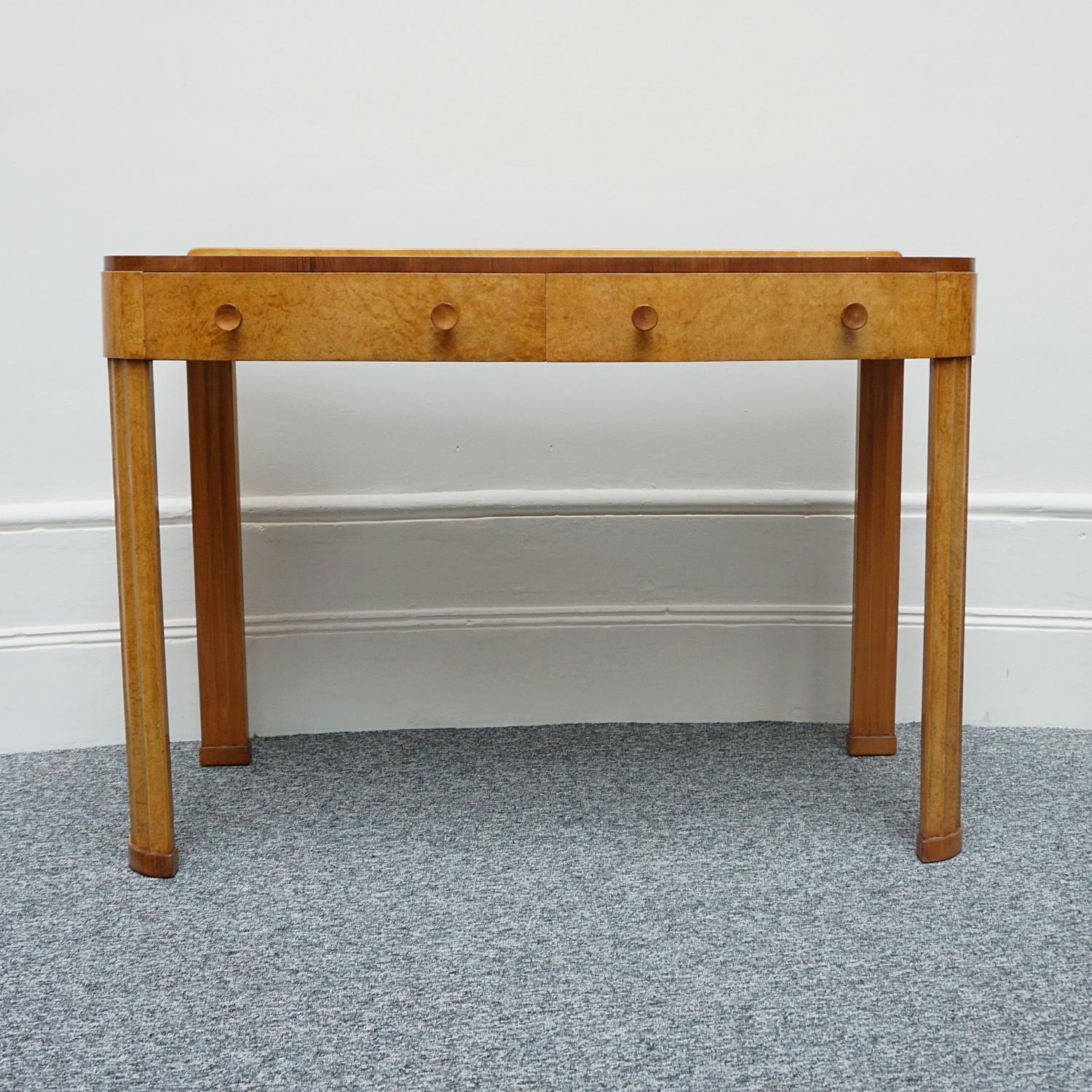 An Art Deco Console table by Harry & Lou Epstein. Burr walnut veneered with figured walnut banding. Original walnut handles and fluted curved legs. 

Dimensions: H 86.5cm, W 122cm, D 57cm.

Origin: English

Date: Circa 1930

Item Number: