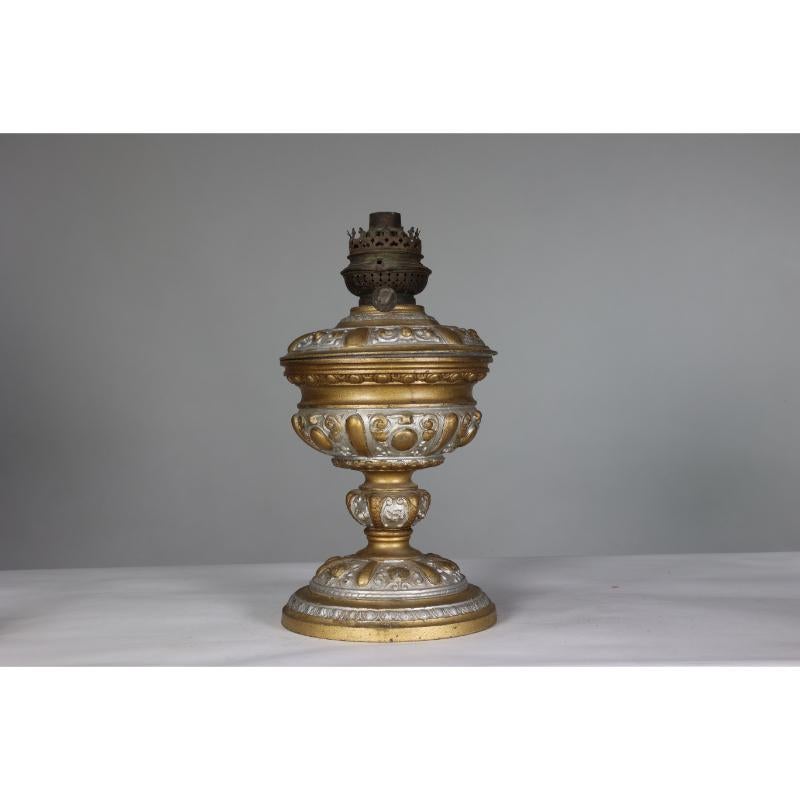 An original French Rococo style cast alloy and painted oil lamp with a glass reservoir. Reservoir requires resetting with plaster of paris.
