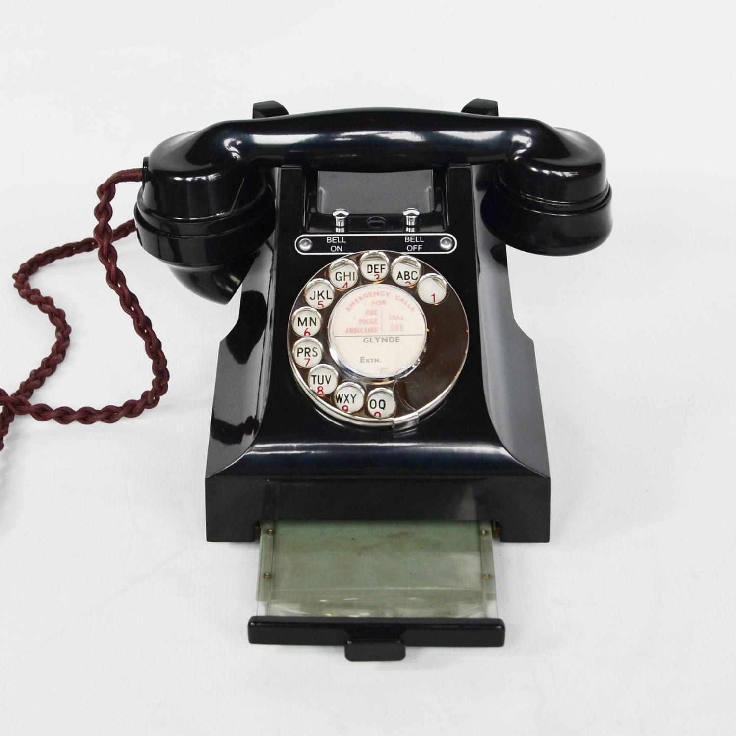 An original GPO model 328L telephone. Black Bakelite with integral drawer and braided handset cord. Registered number to face. Bell on or bell off buttons.

Dimensions: H 15cm, W 20cm, D 16cm

Origin: English

Date: 1948

Item No: