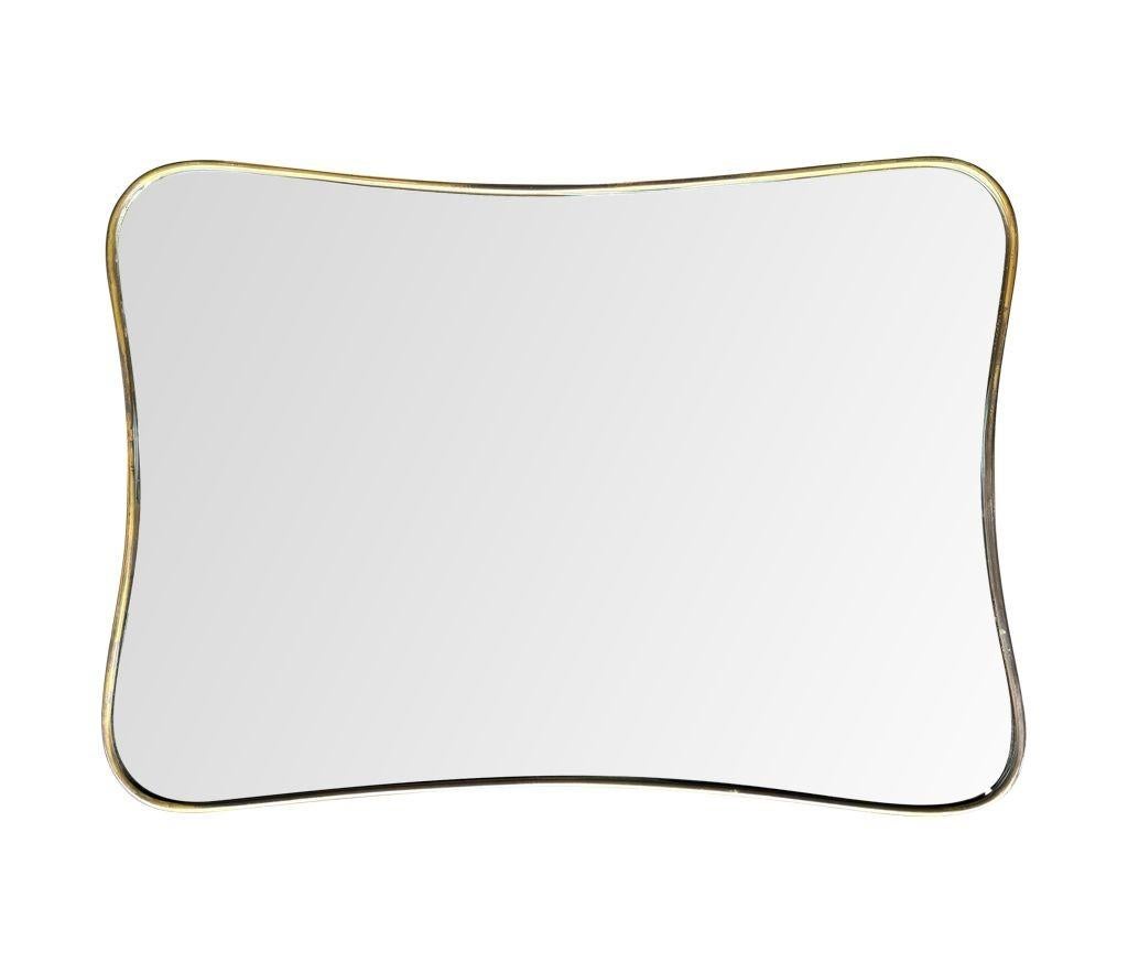 An original Italian 1950s brass framed mirror with shaped curved corners. In Good Condition For Sale In London, GB