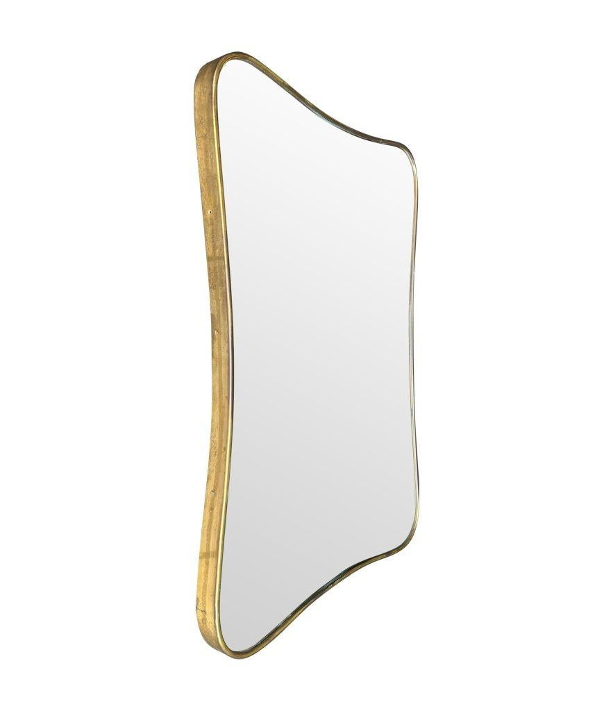Mid-20th Century An original Italian 1950s brass framed mirror with shaped curved corners. For Sale