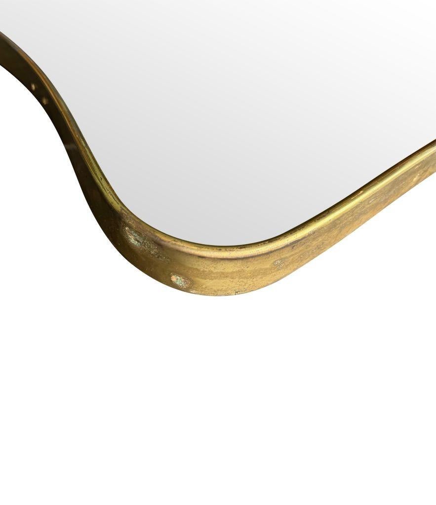 An original Italian 1950s brass framed mirror with shaped curved corners. For Sale 2