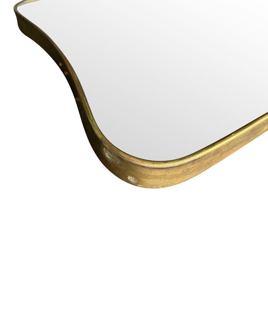 An original Italian 1950s brass framed mirror with shaped curved corners. For Sale 4