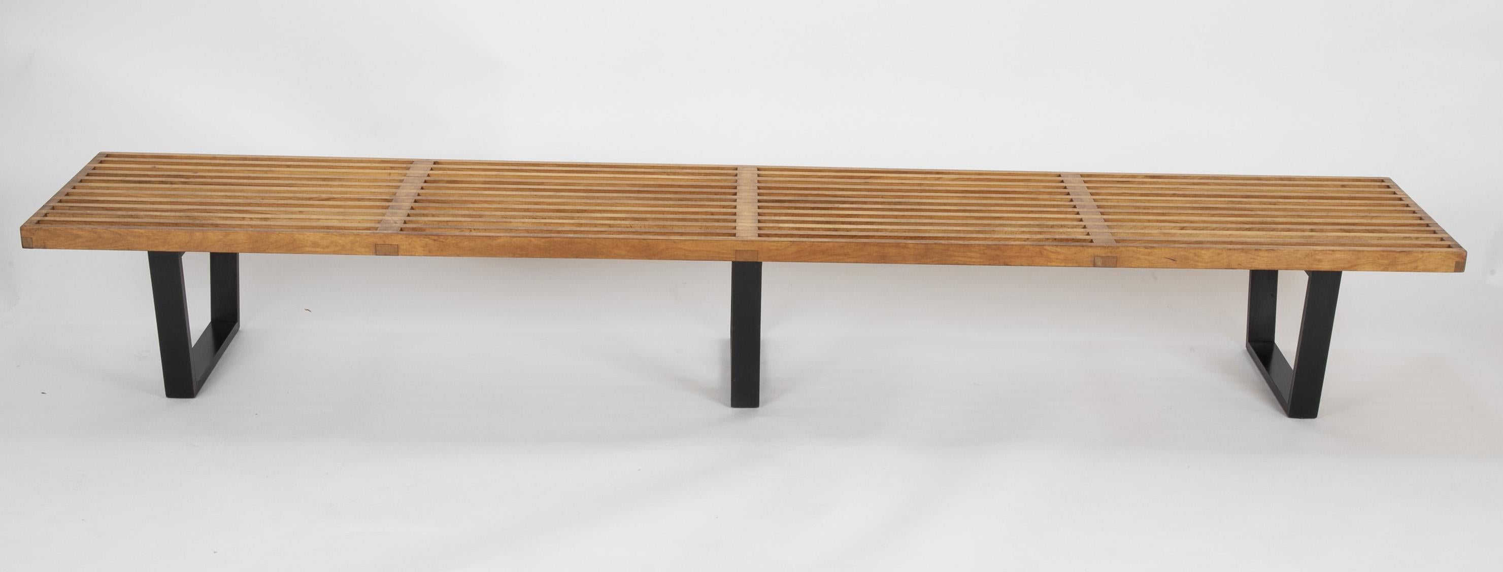 An original production design by George Nelson for Herman Miller, the slat bench with ebonized legs is both clean and timeless. This bench retains both its original patina and tin 