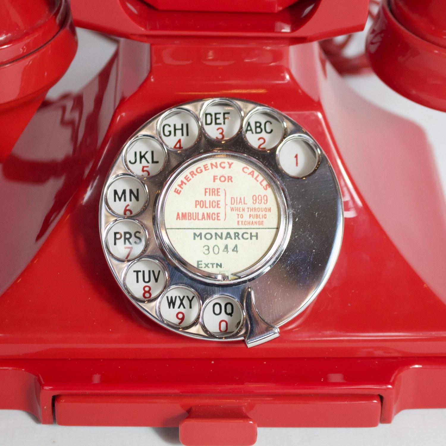 An original GPO 200 series telephone. Red Bakelite with braided handset cord. Integral drawer and registered number to face. 1/232. Manufactured by Siemens. Replacement modern bell.

Dimensions: H 15 cm, W 19 cm, D 15 cm

Origin: