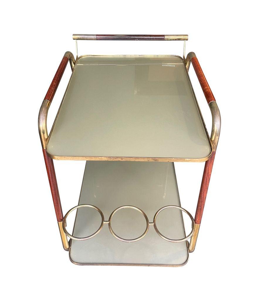 An original unusual designed Italian 1950s lacquered wood and brass bar trolley For Sale 1