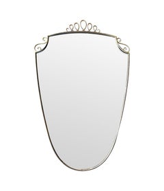 An orignal pair of 1950s Gio Ponti style Italian portrait brass framed mirrors