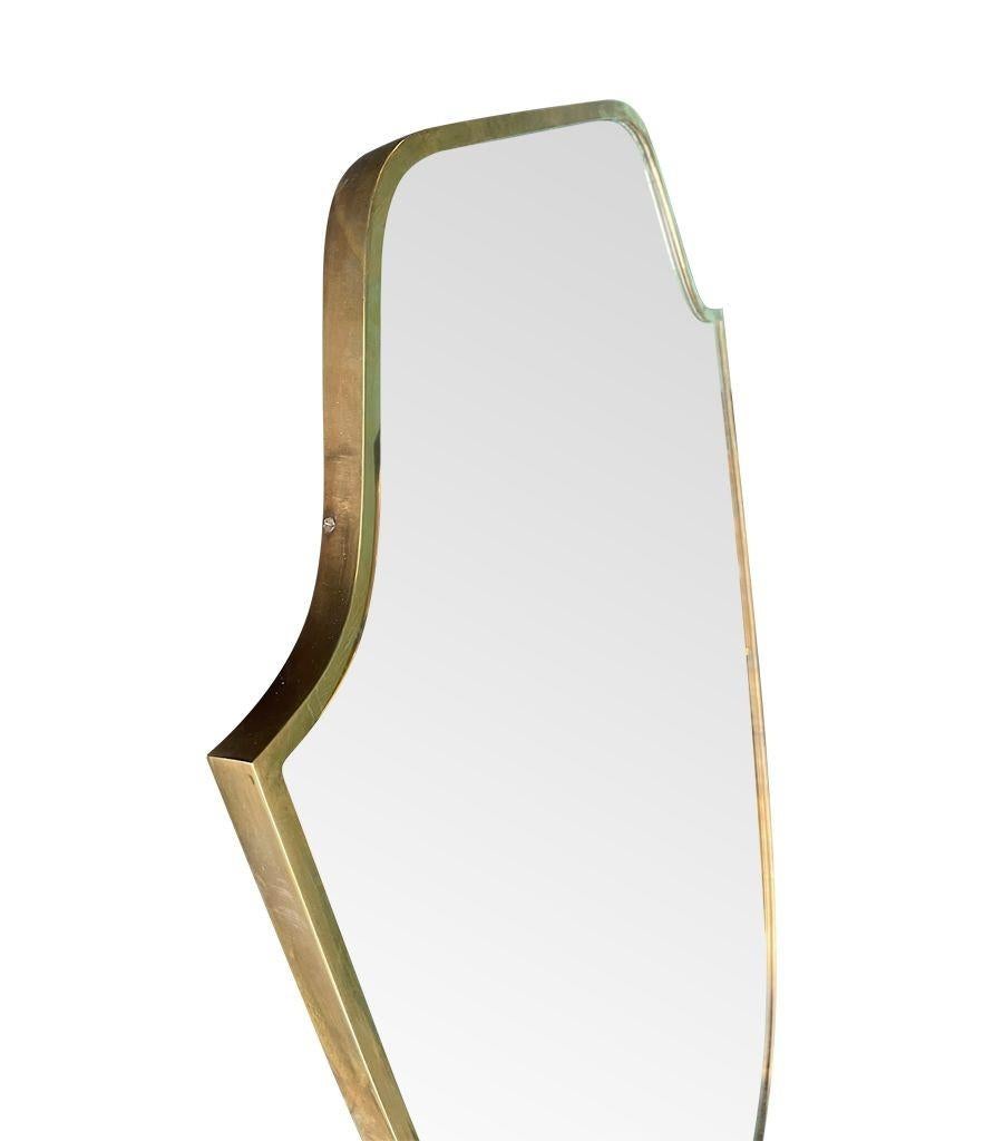 Brass An orignal 1950s Italian shield mirror with solid wood back For Sale