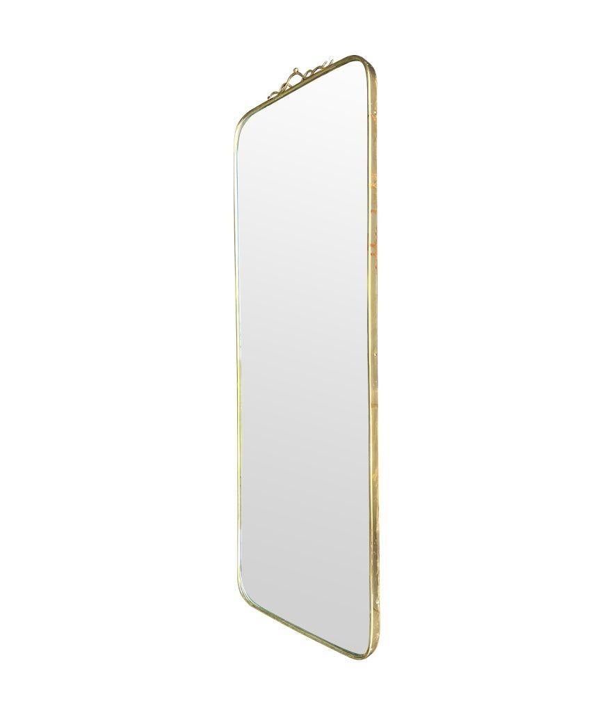 An orignal Italian 1950s brass framed mirror with scroll top detail For Sale 6