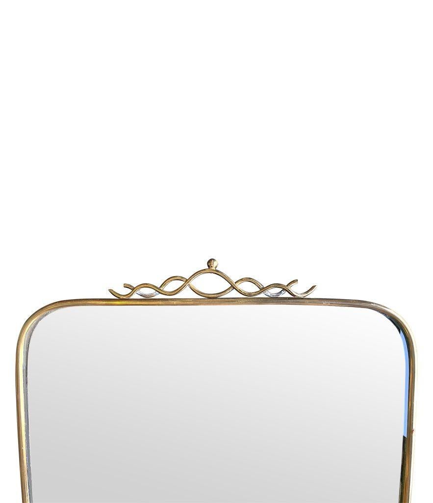 An orignal Italian 1950s brass framed mirror with scroll top detail For Sale 7