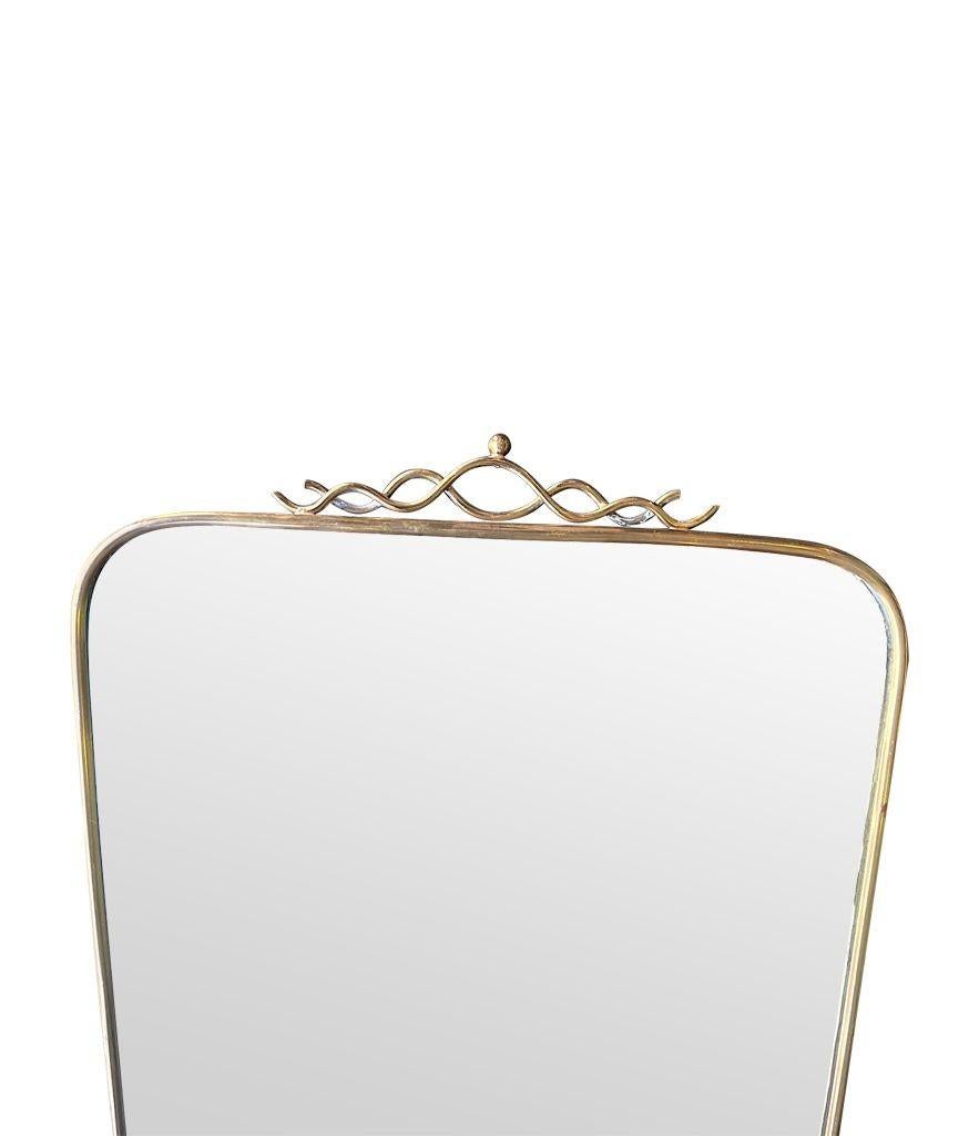 An orignal Italian 1950s brass framed mirror with pretty brass scroll top detail, orignal mirror plate and solid wood back.
