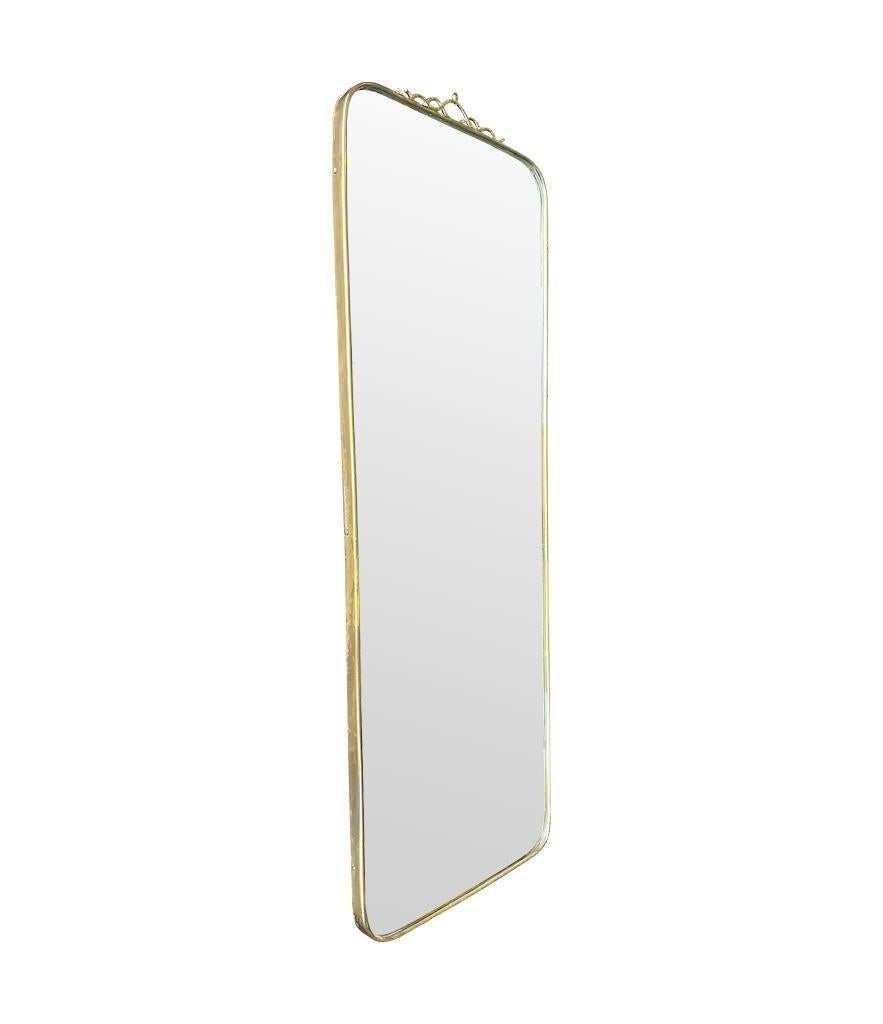Mid-20th Century An orignal Italian 1950s brass framed mirror with scroll top detail For Sale
