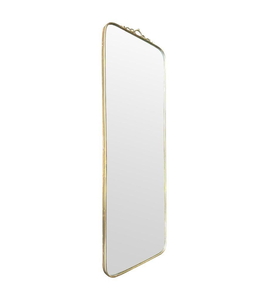 An orignal Italian 1950s brass framed mirror with scroll top detail For Sale 4