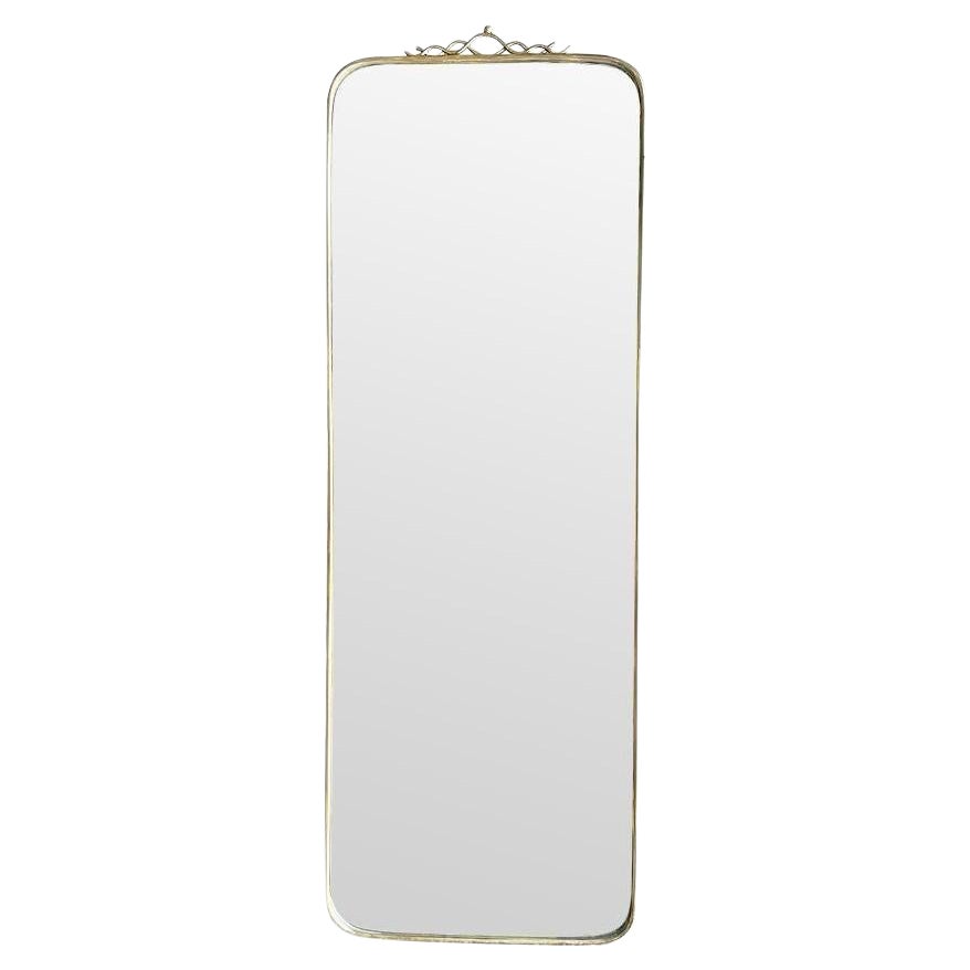 An orignal Italian 1950s brass framed mirror with scroll top detail