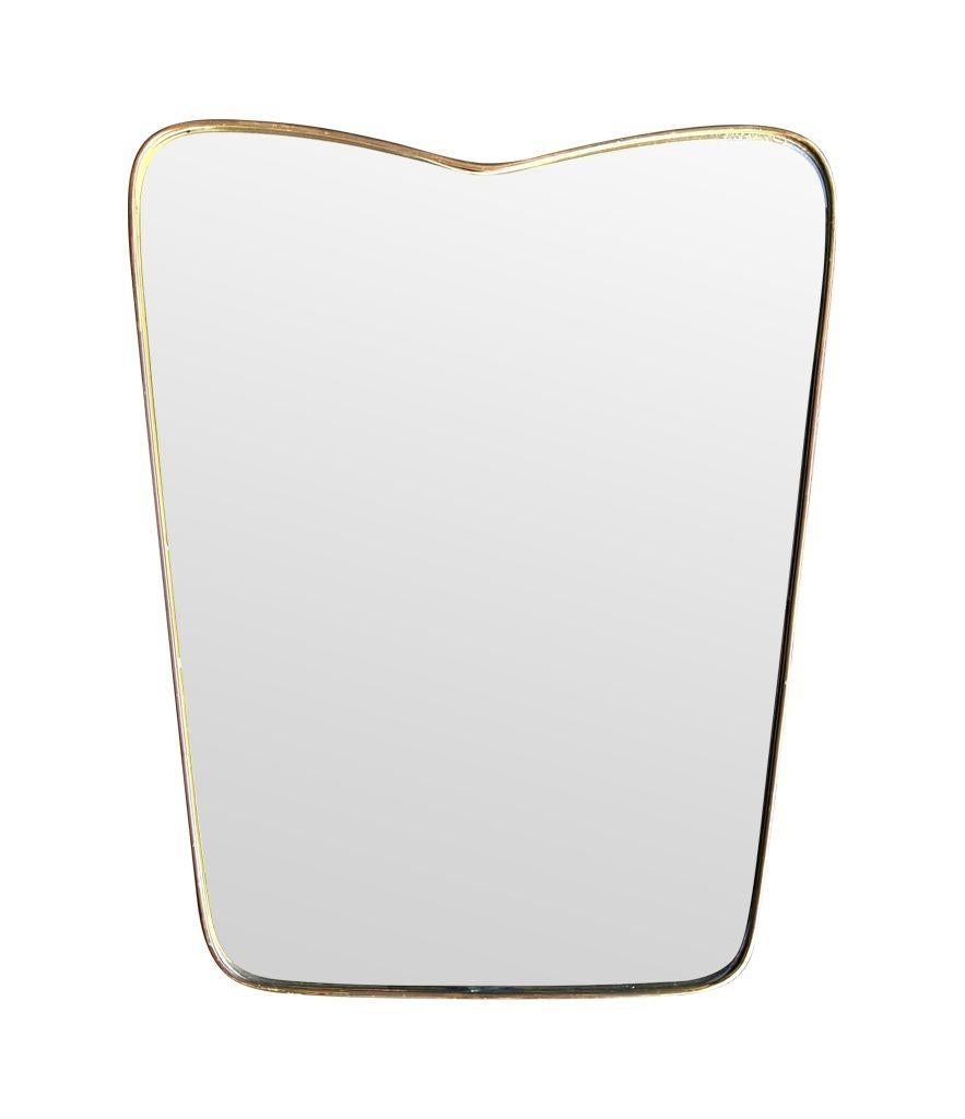 Brass An orignal Italian 1950s brass frmed mirror with shaped top For Sale