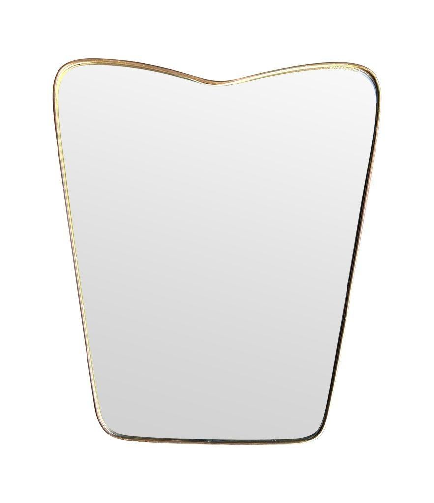 An orignal Italian 1950s brass frmed mirror with shaped top For Sale 2
