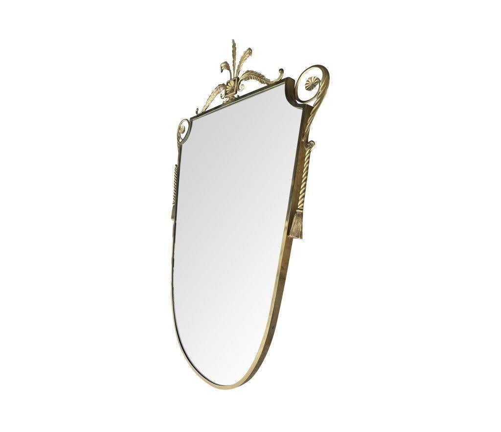 An orignal Italian 1950s shield mirror with decorative central feather finial, scroll corners with brass rope side detail. With orignal plate and solid wooden back.