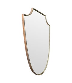 An orignal Italian 1960s brass shield mirror with beaded inner frame detail