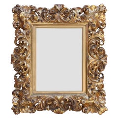 An Ornate Florentine 19th Century Baroque Style Giltwood Carved Mirror Frame