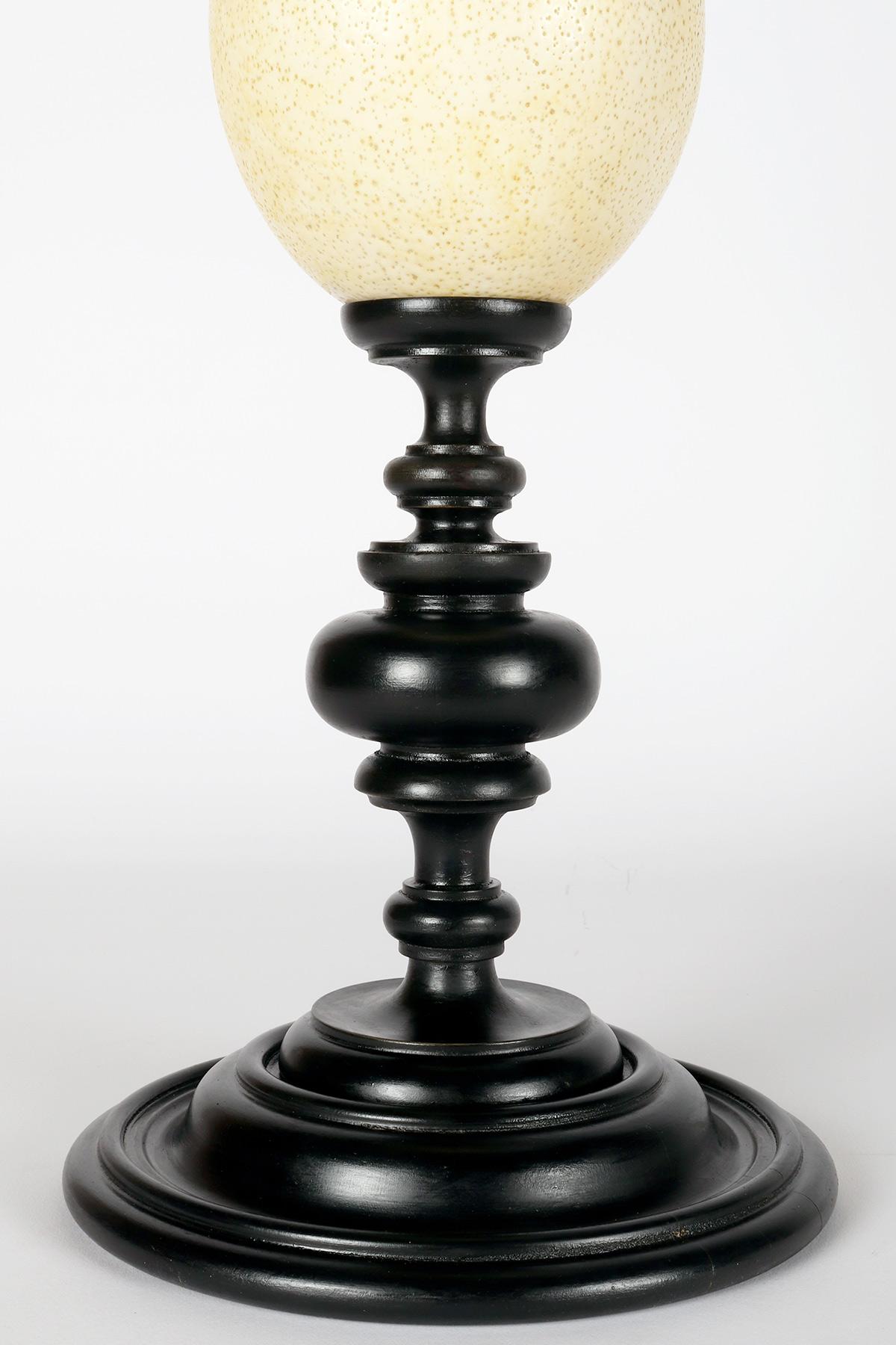 Ostrich Eggshell An ostrich egg from a wunderkammer, with an ebonized wooden base, Italy 1900. For Sale