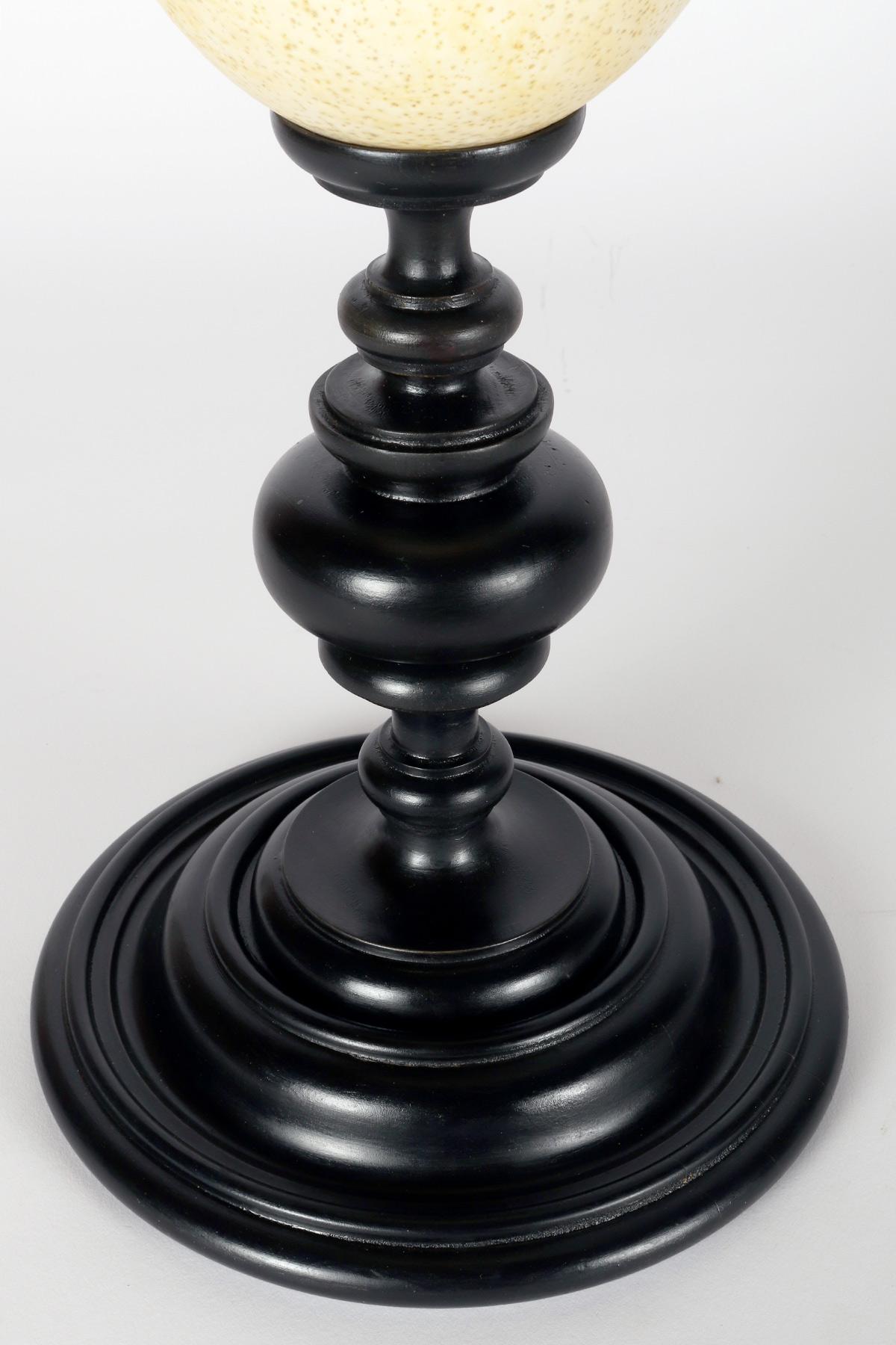 An ostrich egg from a wunderkammer, with an ebonized wooden base, Italy 1900. For Sale 1