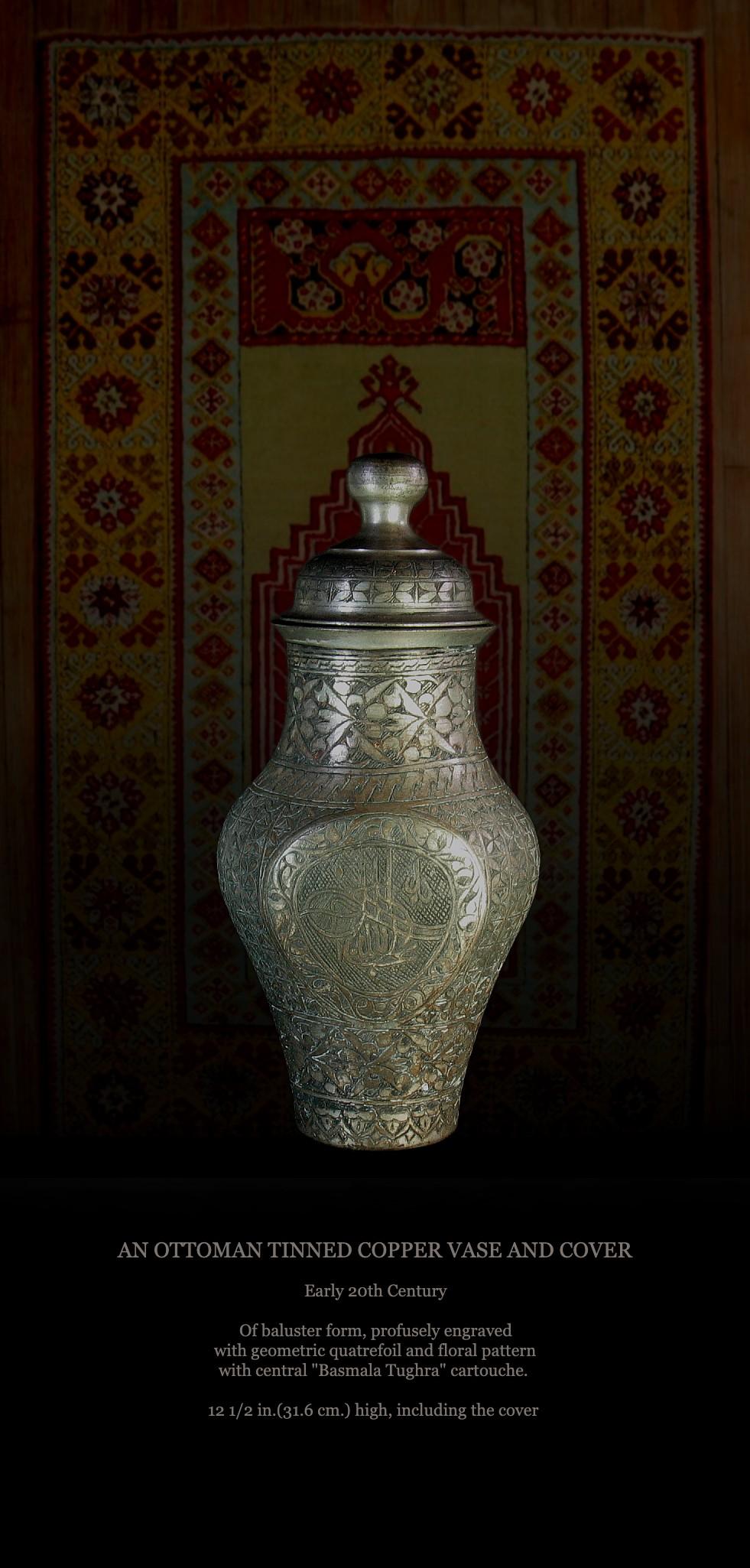 AN OTTOMAN TINNED COPPER VASE AND COVER
Early 20th Century.

Of baluster form, profusely engraved with geometric quatrefoil and floral pattern with central 