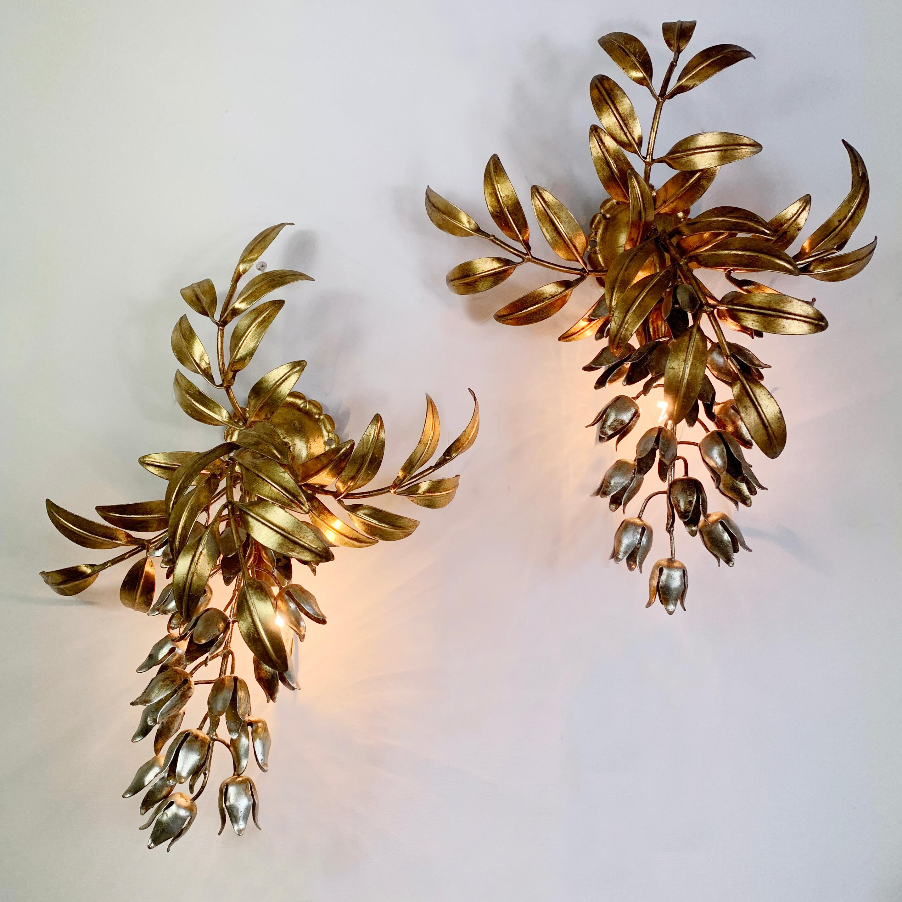 A beautiful and rare pair of matched original Hans Kogl Pioggia D'oro wall lights

Each lamp comprises large gold plated leaved branches with hanging silver wisteria flowers by the world renowned designer Hans Kogl

Each sconce takes a single