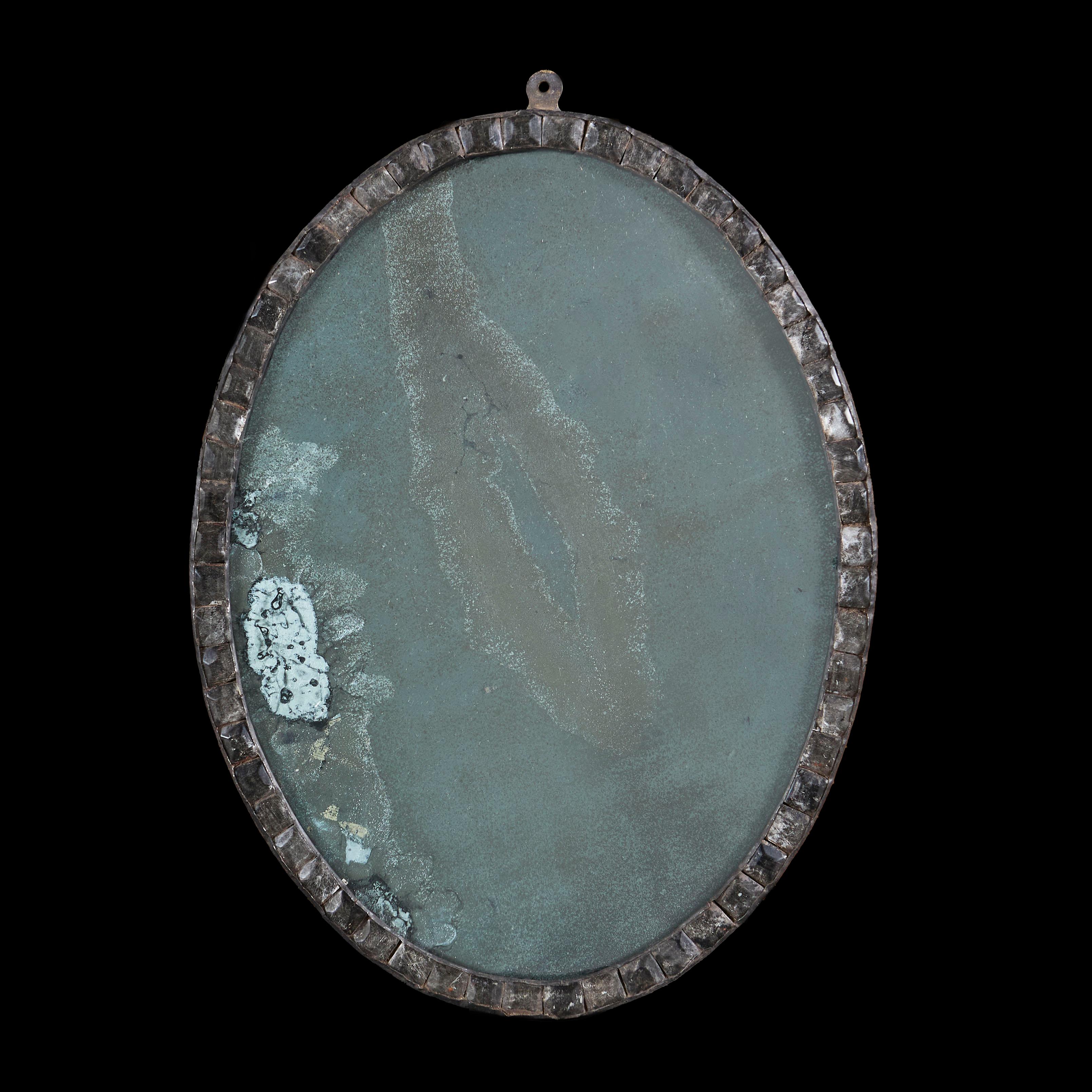 Ireland, circa 1900

An early twentieth century oval Irish mirror with a border comprised of clear cut glass beads with heavily oxidised mercury mirror plate.

Height 60.00cm
Width 45.00cm
Depth 4.00cm