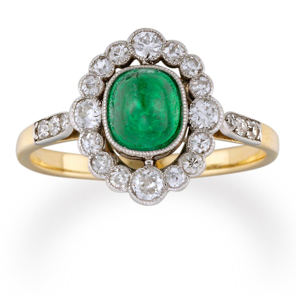 Modern An Oval Emerald And Diamond Cluster Ring For Sale